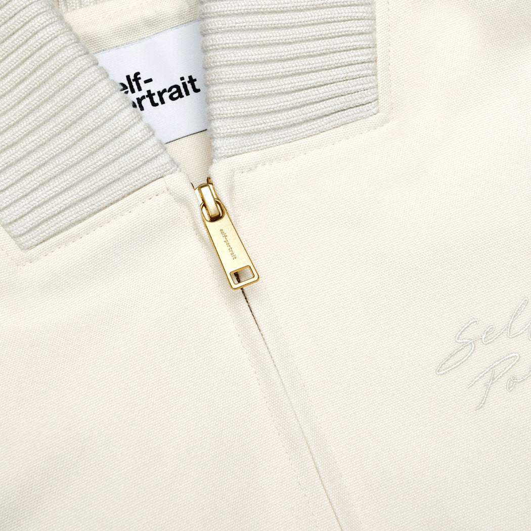 A close up of the fabric for the Cream Cotton Canvas Jacket