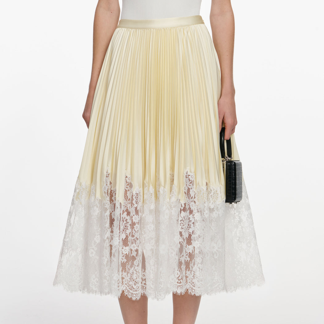 A close up of a woman wearing the Yellow Satin Lace Midi Skirt