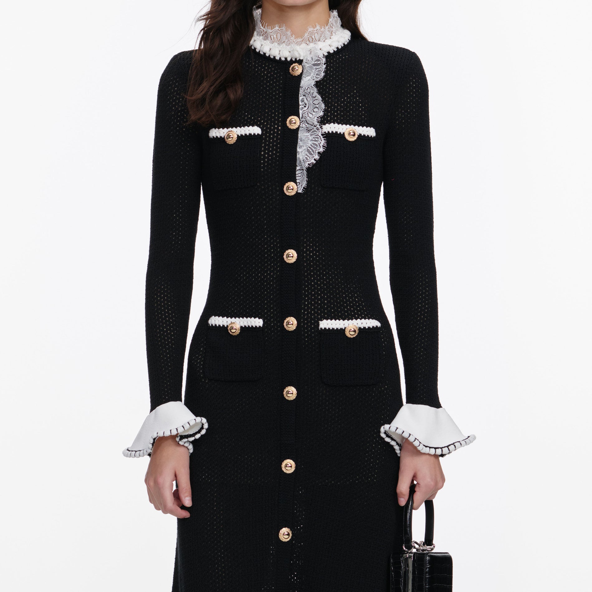 A close up of a woman wearing the Black Lace Trim Knit Midi Dress