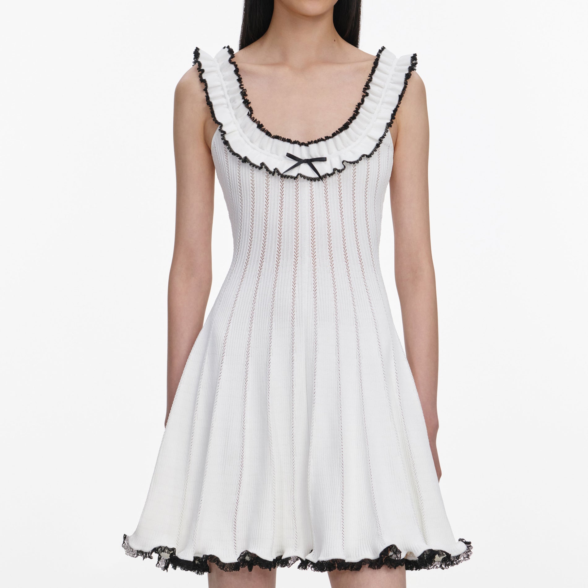 A close up of a woman wearing the White Contrast Trim Knit Mini Dress