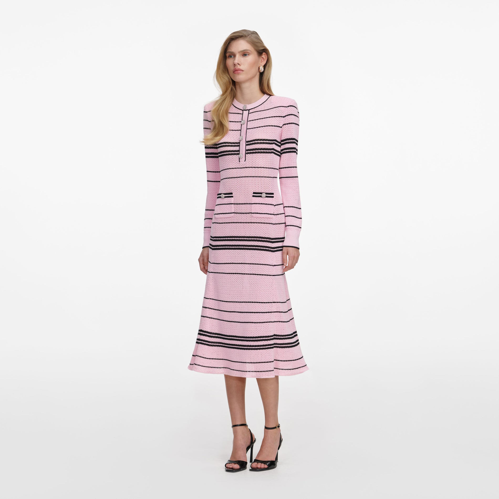 Side view of a woman wearing the Pink Stripe Knit Midi Dress