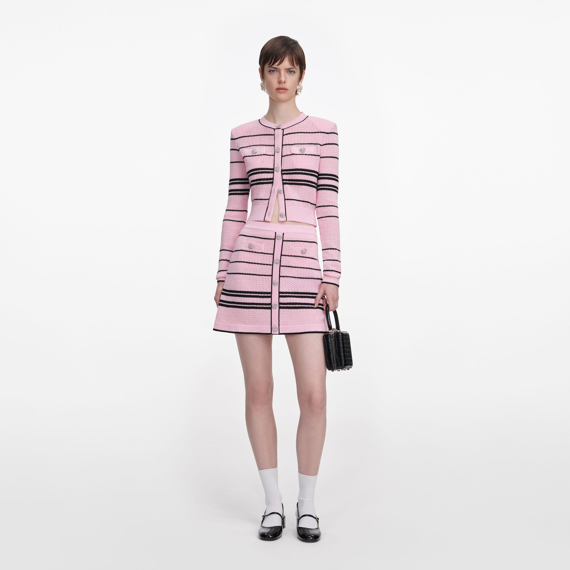 Front view of a woman wearing the Pink Stripe Knit Mini Skirt