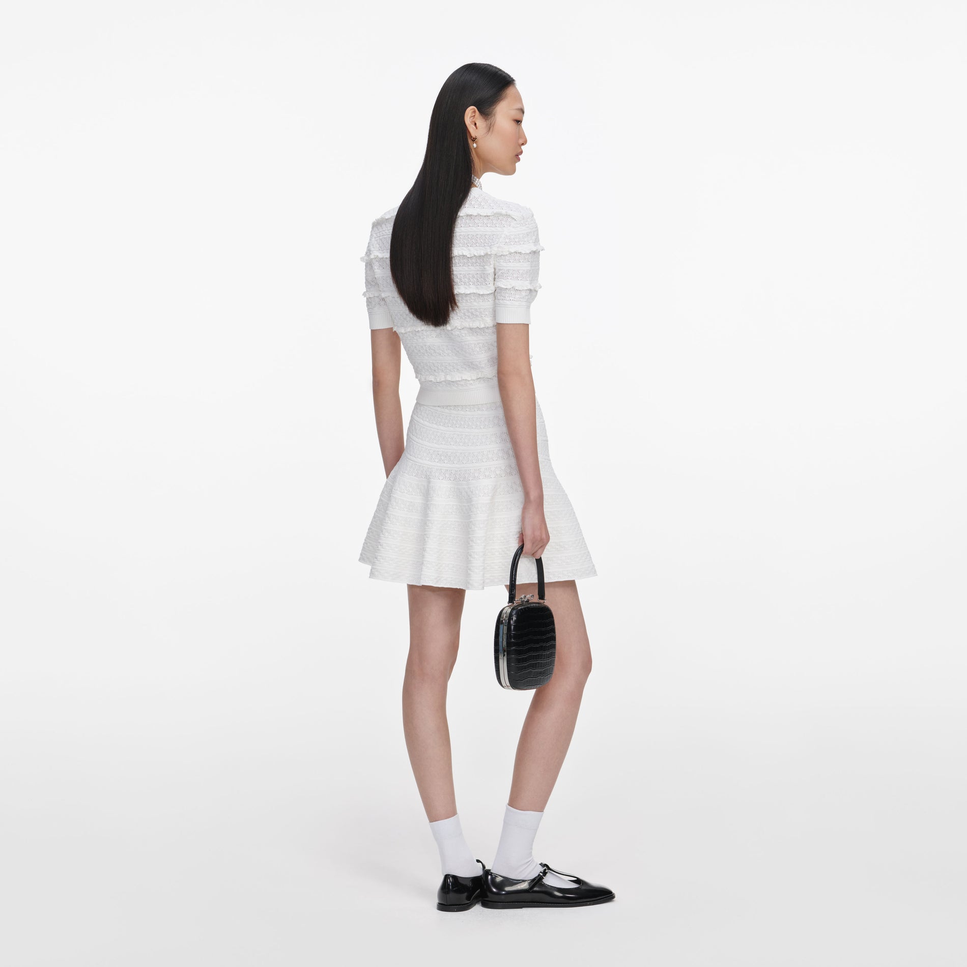 Back view of a woman wearing the White Pointelle Knit Top