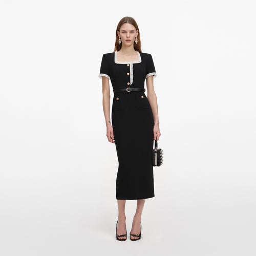 A close up of a woman wearing the Black Crepe Contrast Frill Midi Dress