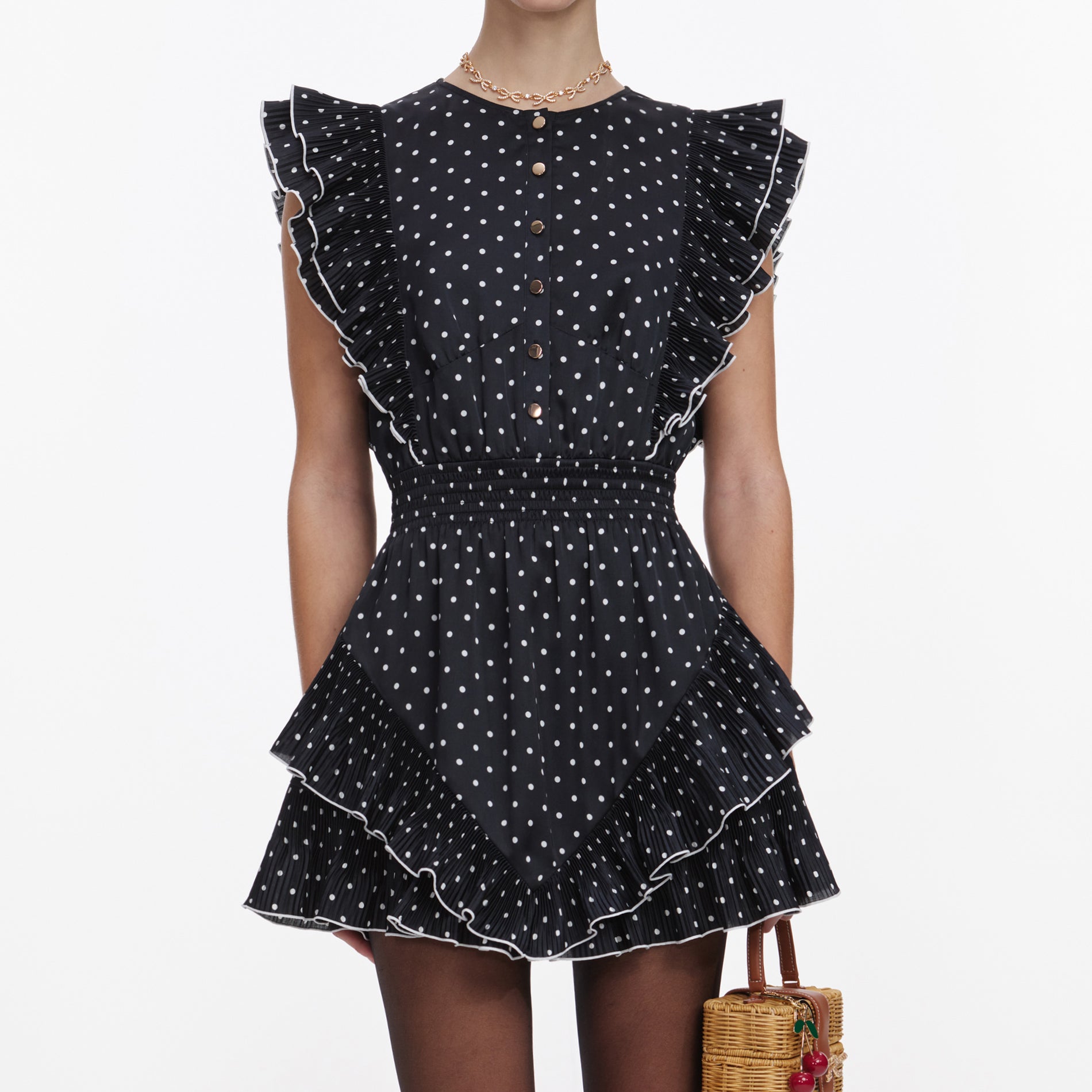A close up of a woman wearing the Black Polka Dot Frill Mini Dress