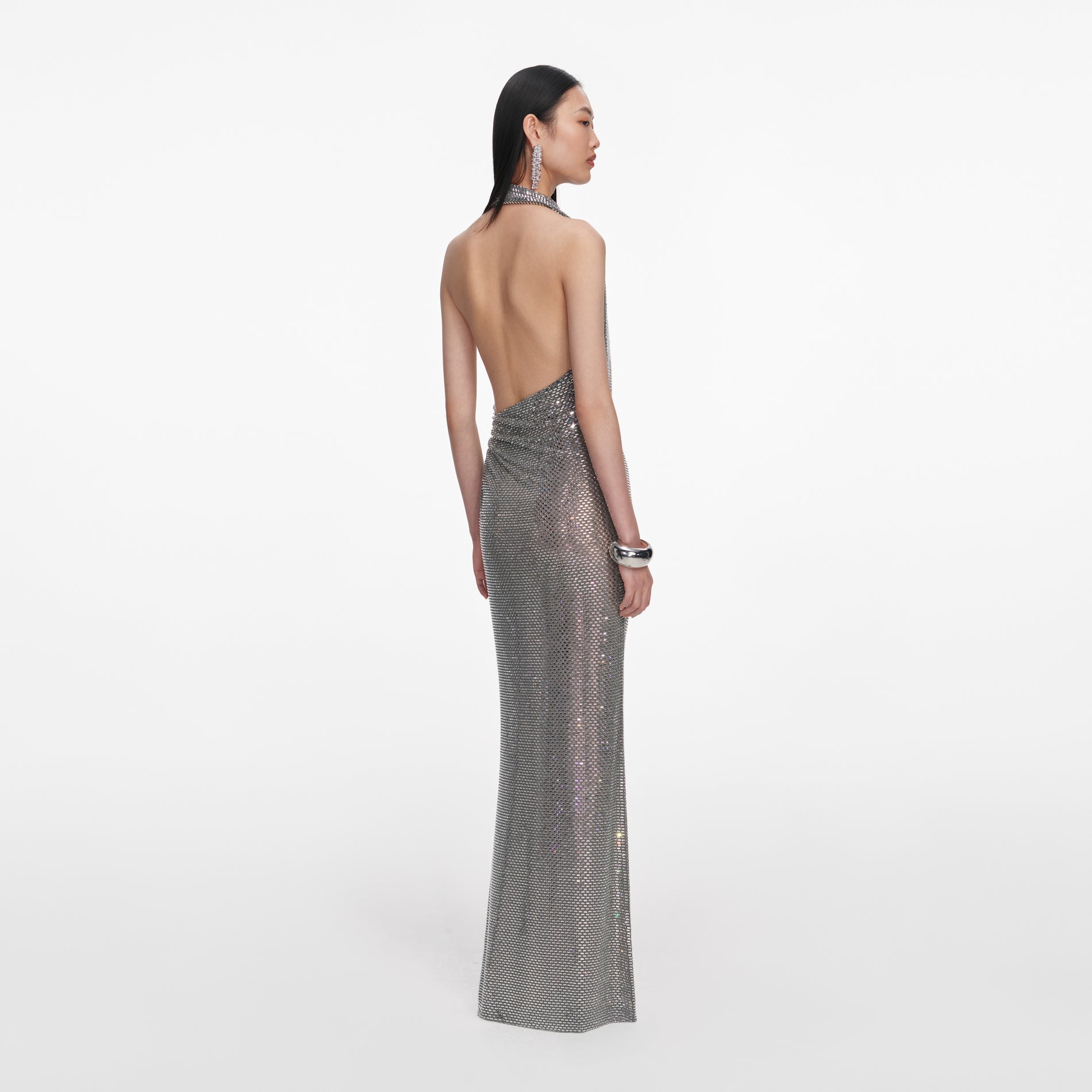Back view of a woman wearing the Grey Rhinestone Drape Maxi Dress