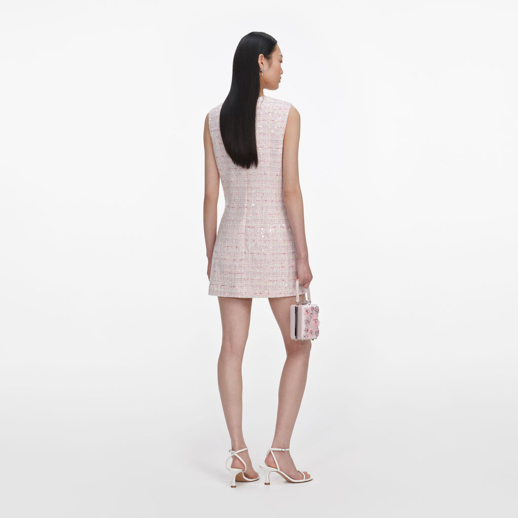 Back view of a woman wearing the Pink Sequin Boucle Bow Mini Dress
