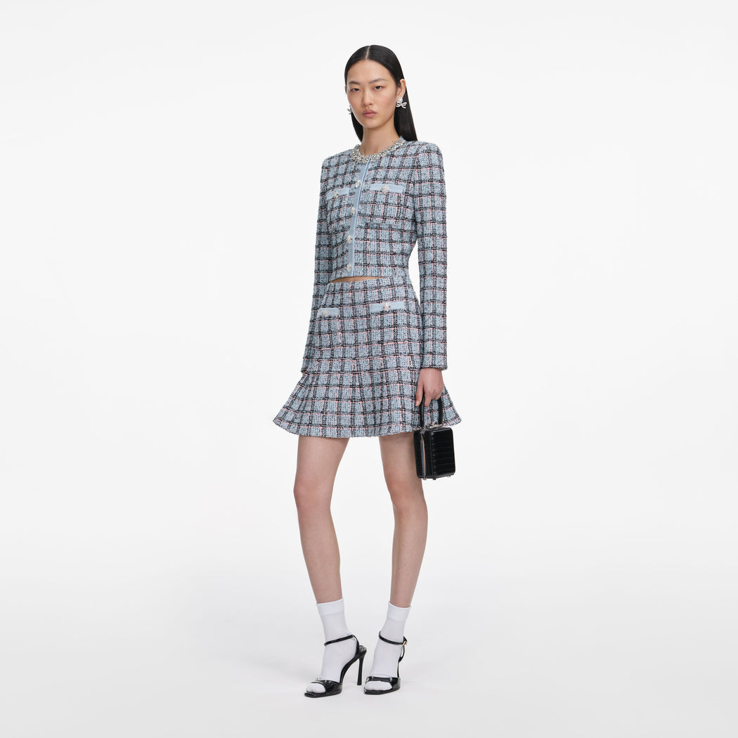 Side view of a woman wearing the Blue Check Knit Mini Skirt