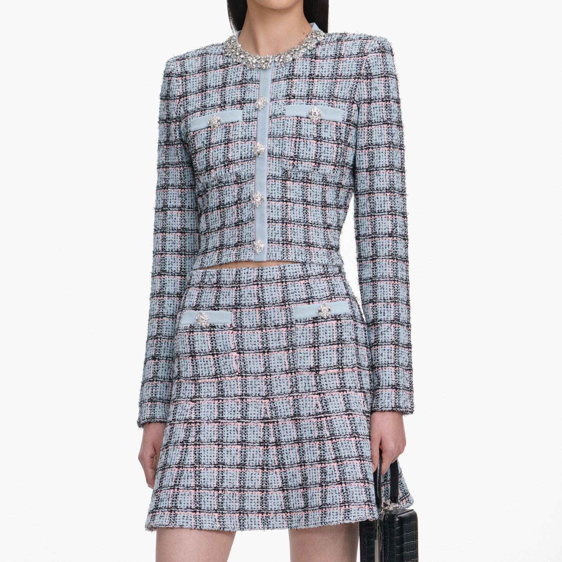 A close up of a woman wearing the Blue Check Knit Mini Skirt