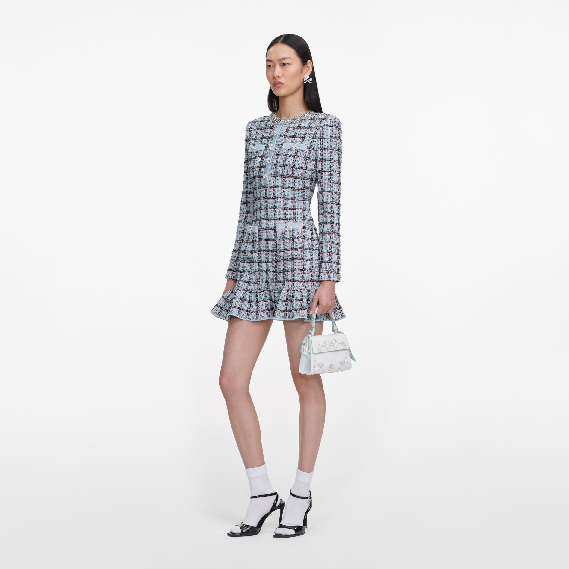 Side view of a woman wearing the Blue Check Knit Mini Dress