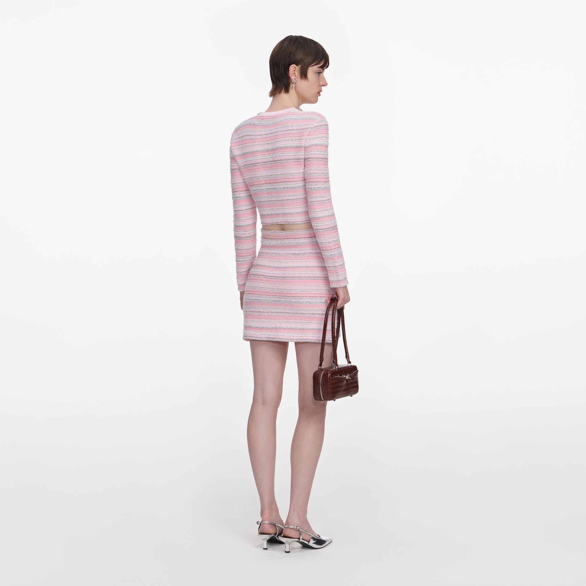Back view of a woman wearing the Pink Textured Knit Mini Skirt