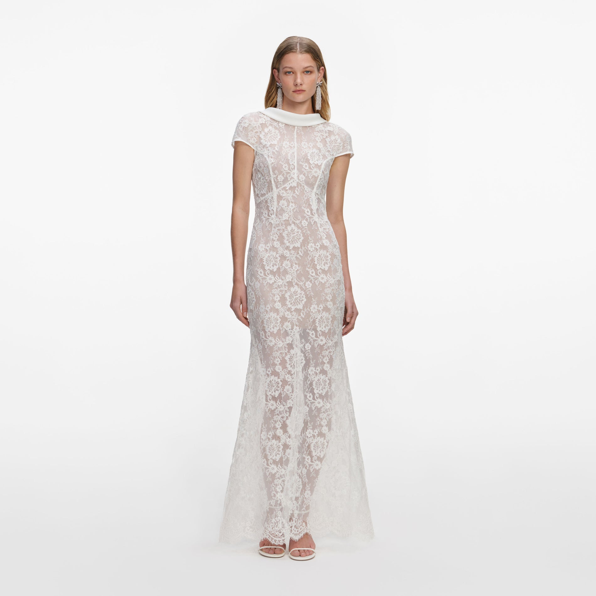 Front view of a woman wearing the White Lace Scoop Back Maxi Dress