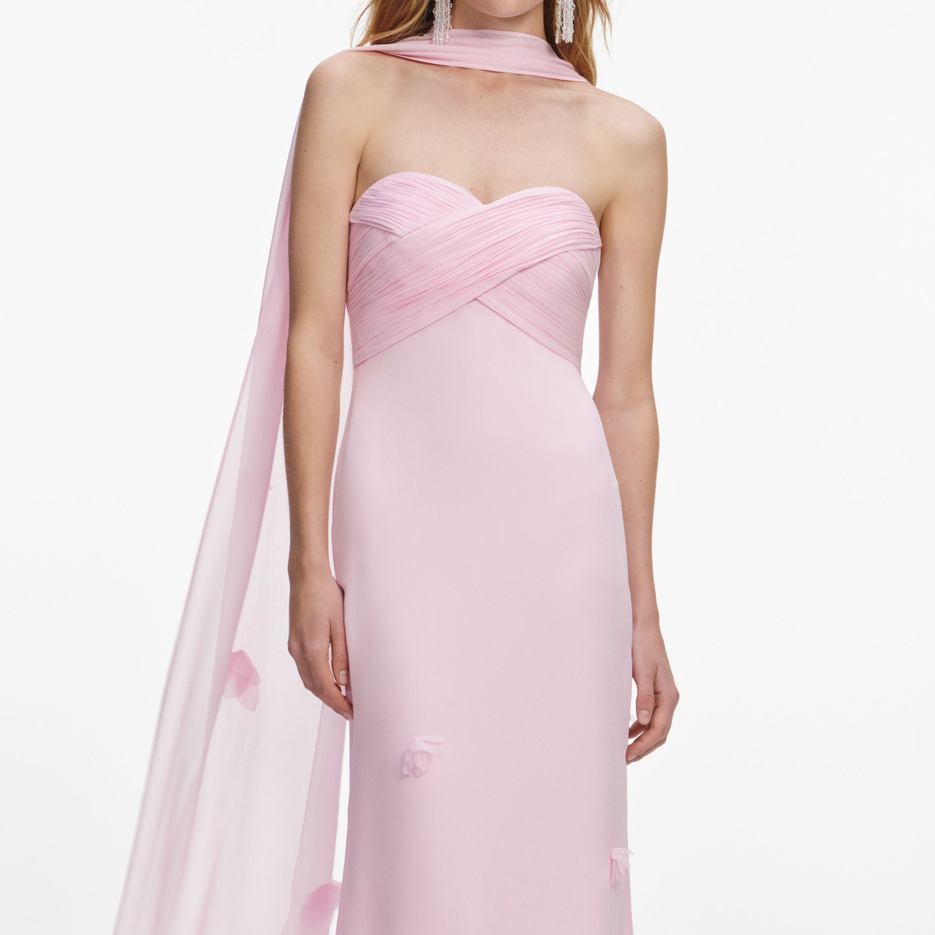 A close up of a woman wearing the Pink Georgette Scarf Maxi Dress