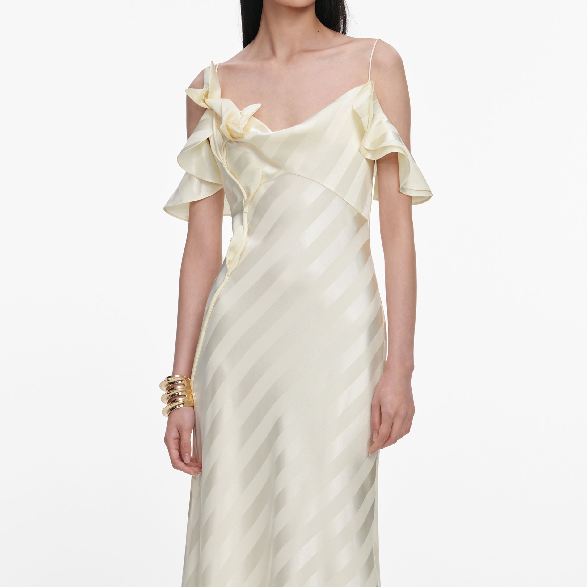 A close up of a woman wearing the Yellow Satin Striped Maxi Dress