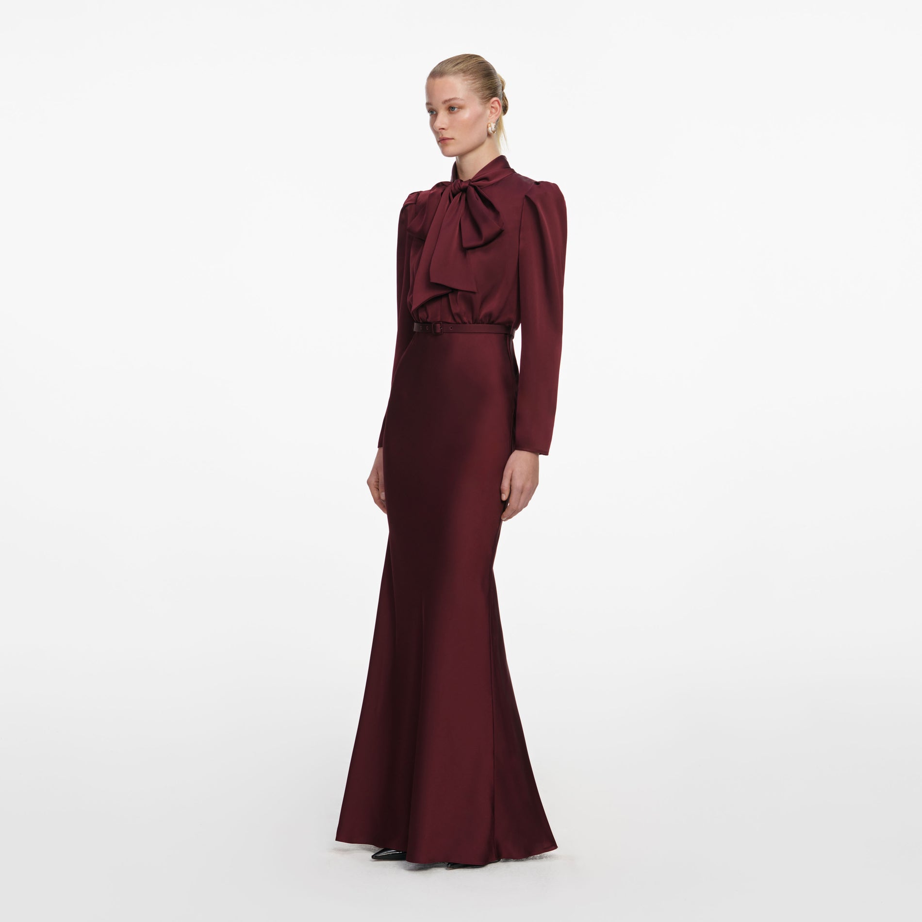 Side view of a woman wearing the Burgundy Tie Neck Satin Maxi Dress