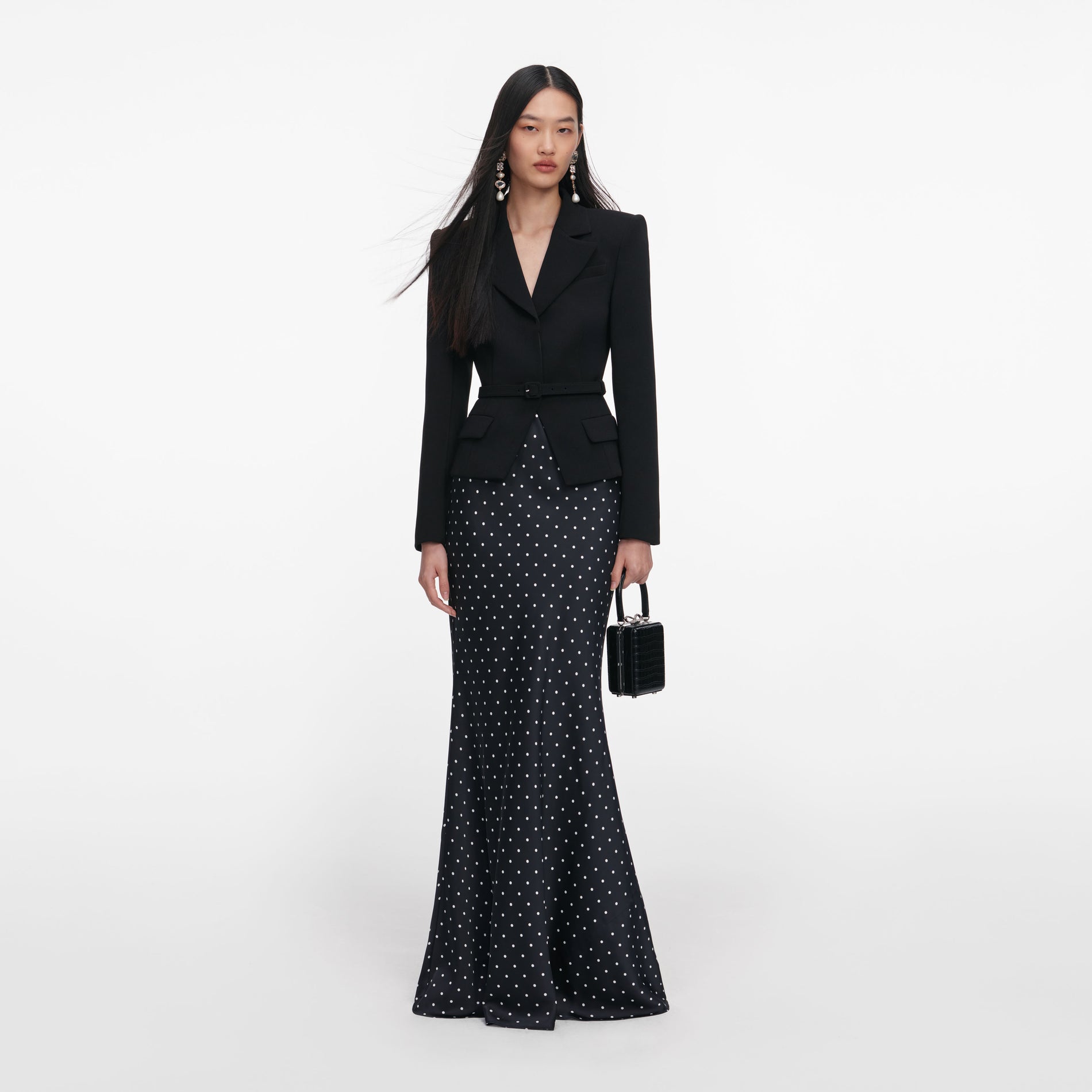 Front view of a woman wearing the Black Crepe Polka Dot Maxi Dress