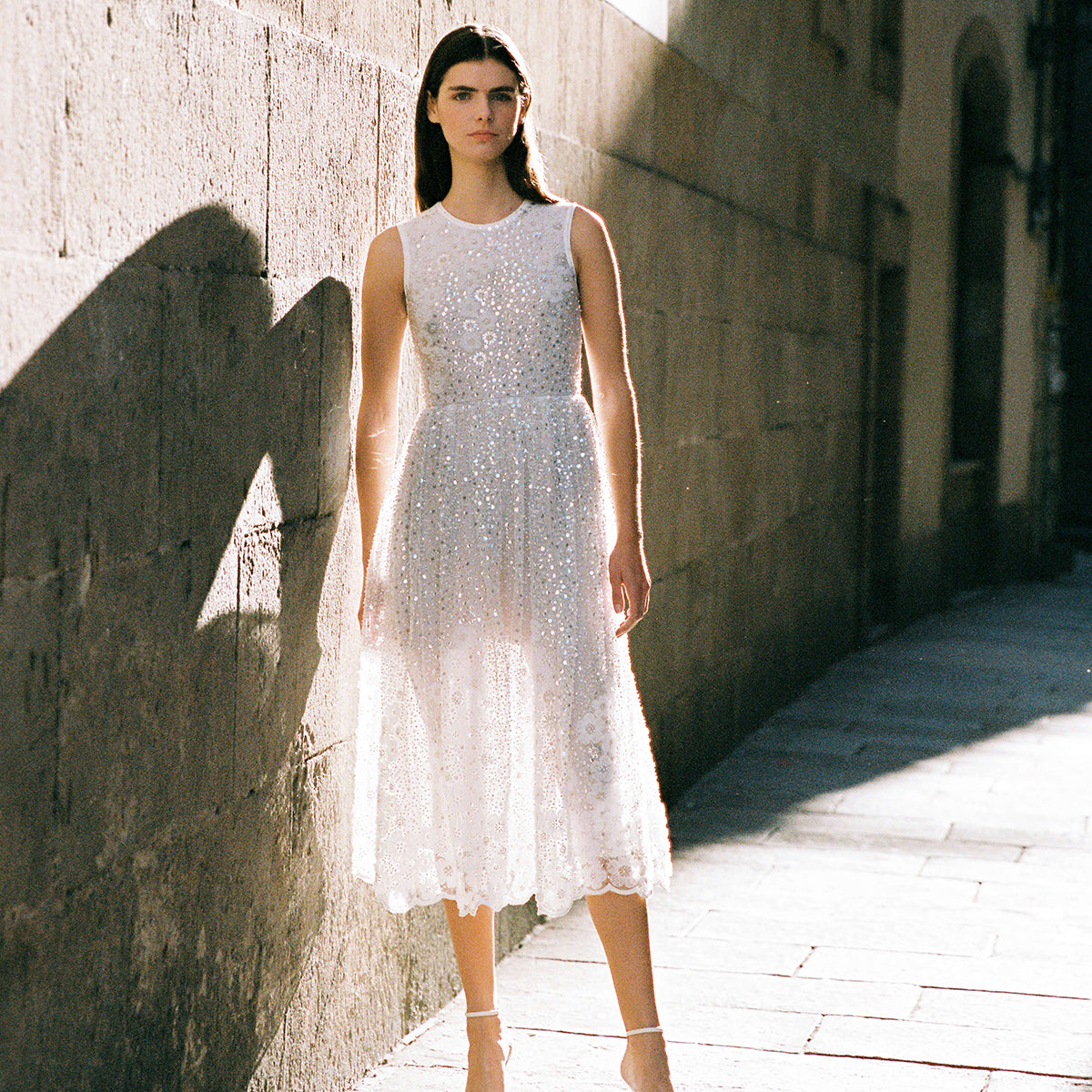 A woman wearing the White Beaded Sequin Midi Dress