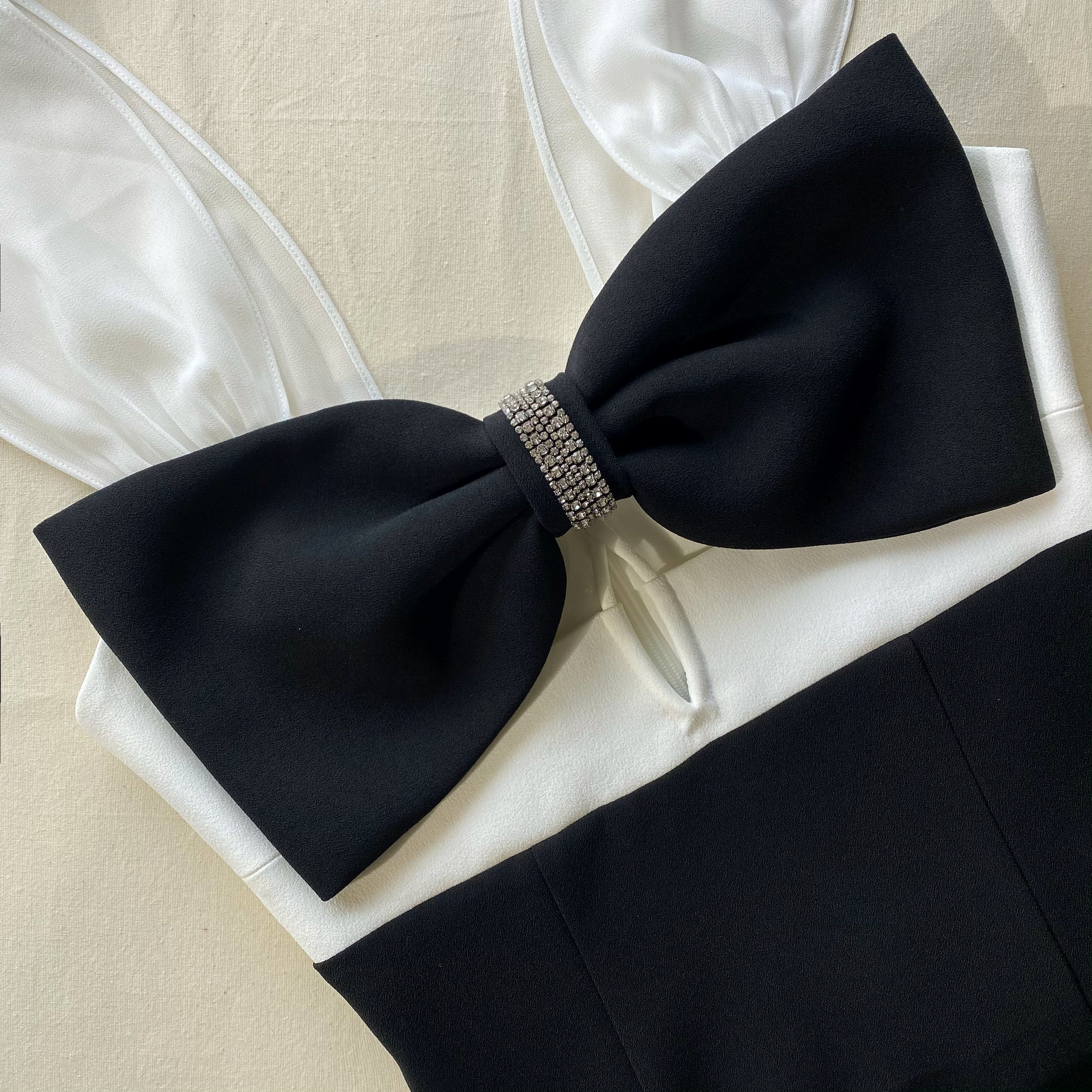 A close up of the fabric for the Black And White Crepe Bow Midi Dress