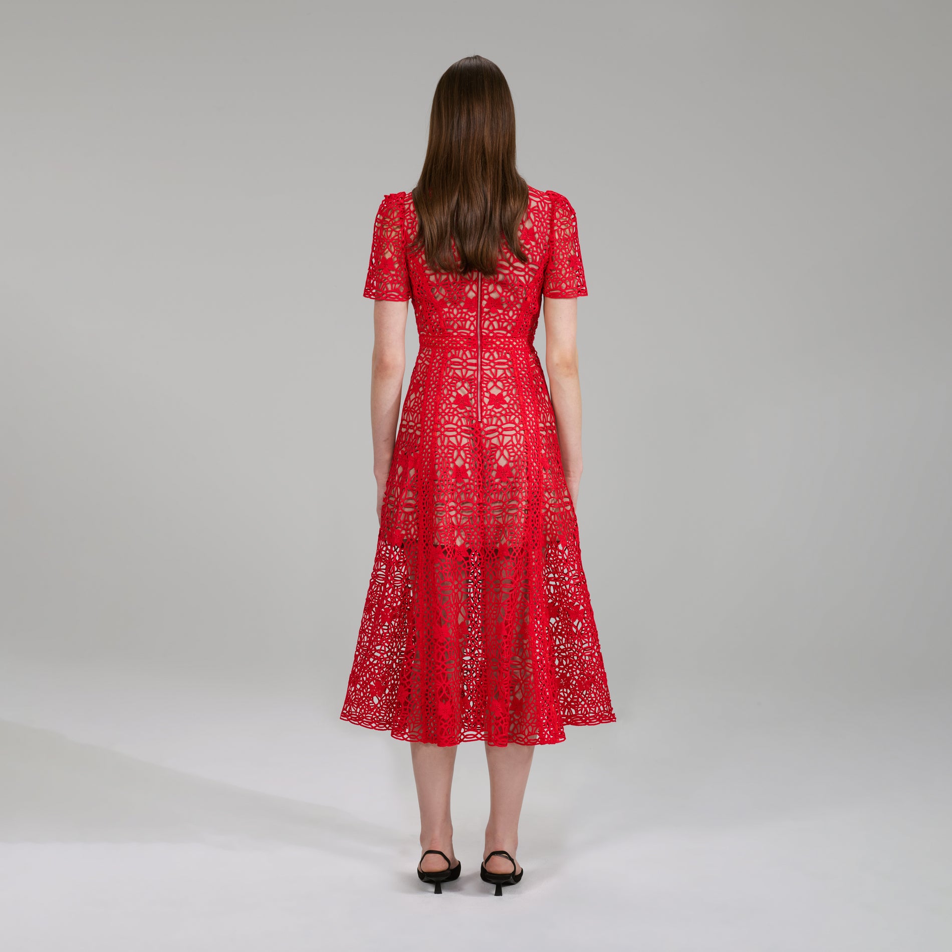 A woman wearing the Red Guipure Lace Midi Dress