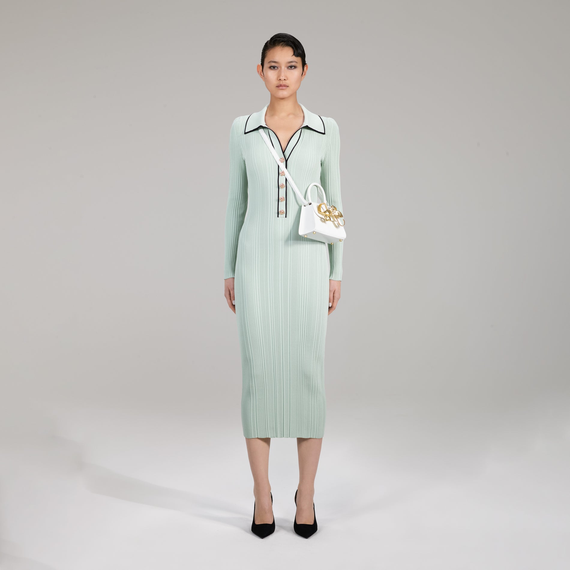A woman wearing the Pale Green Contrast Stitch Knit Dress