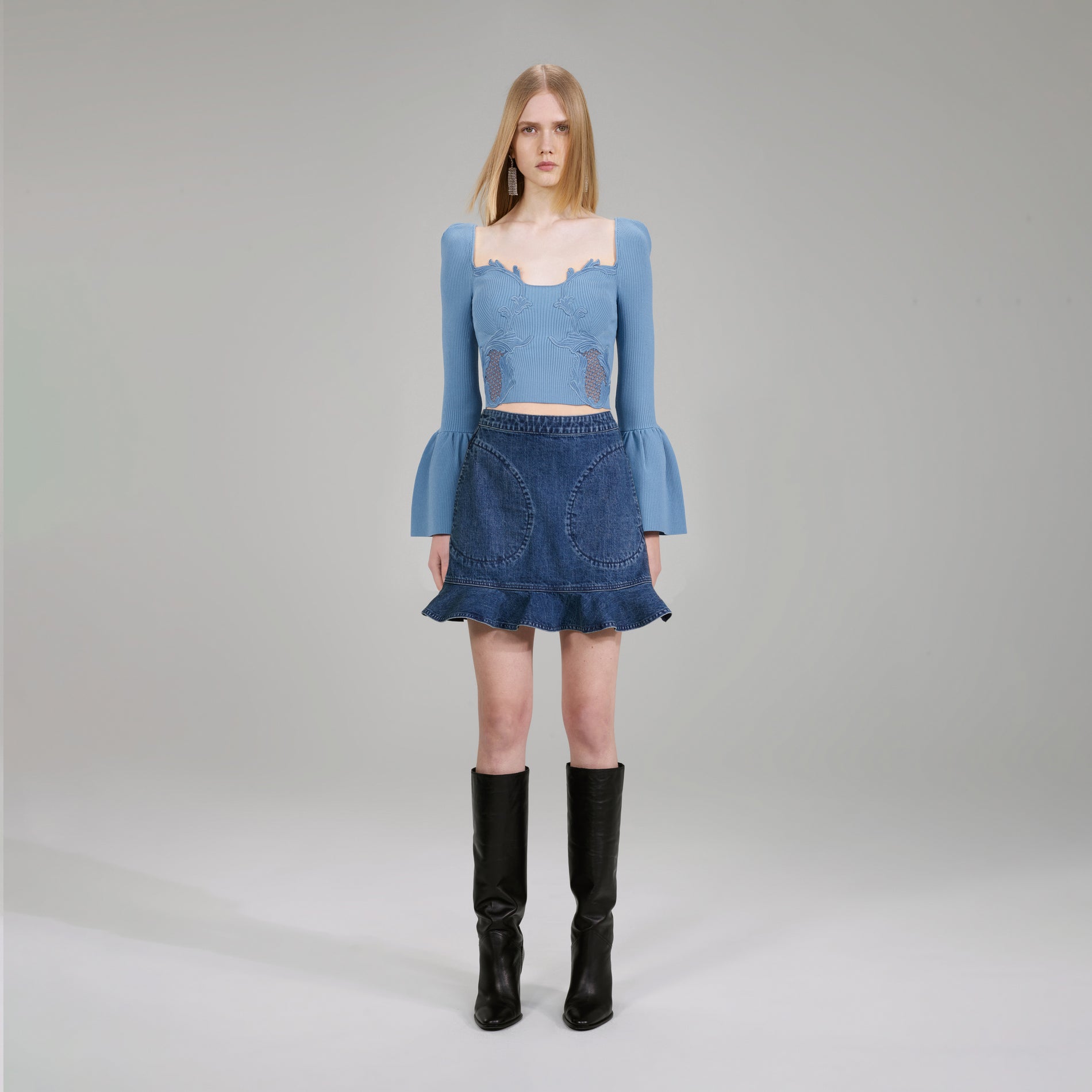 A woman wearing the Pastel Blue Lace Insert Ribbed Knit Top