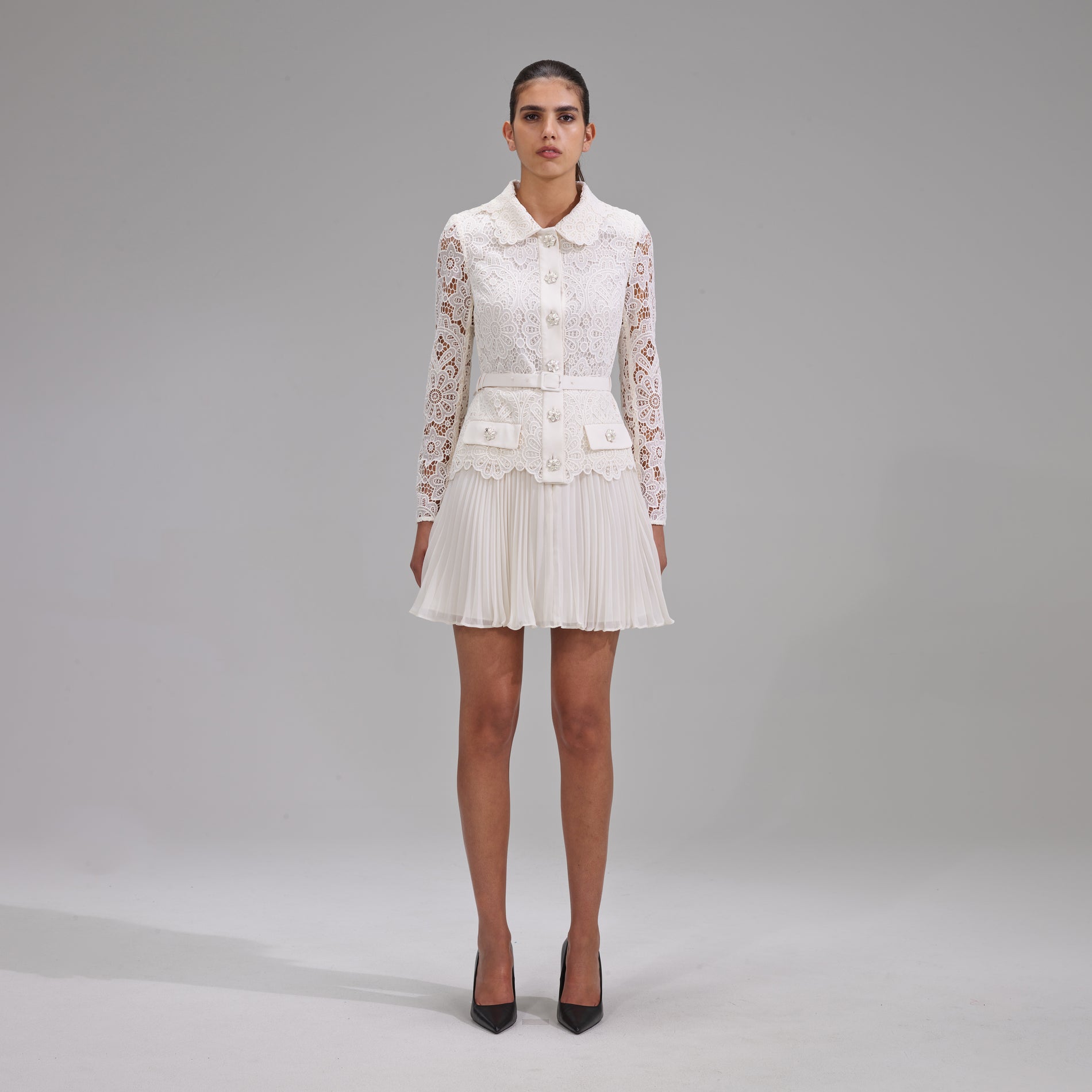 A woman wearing the Ivory Floral Motif Guipure Mini Dress