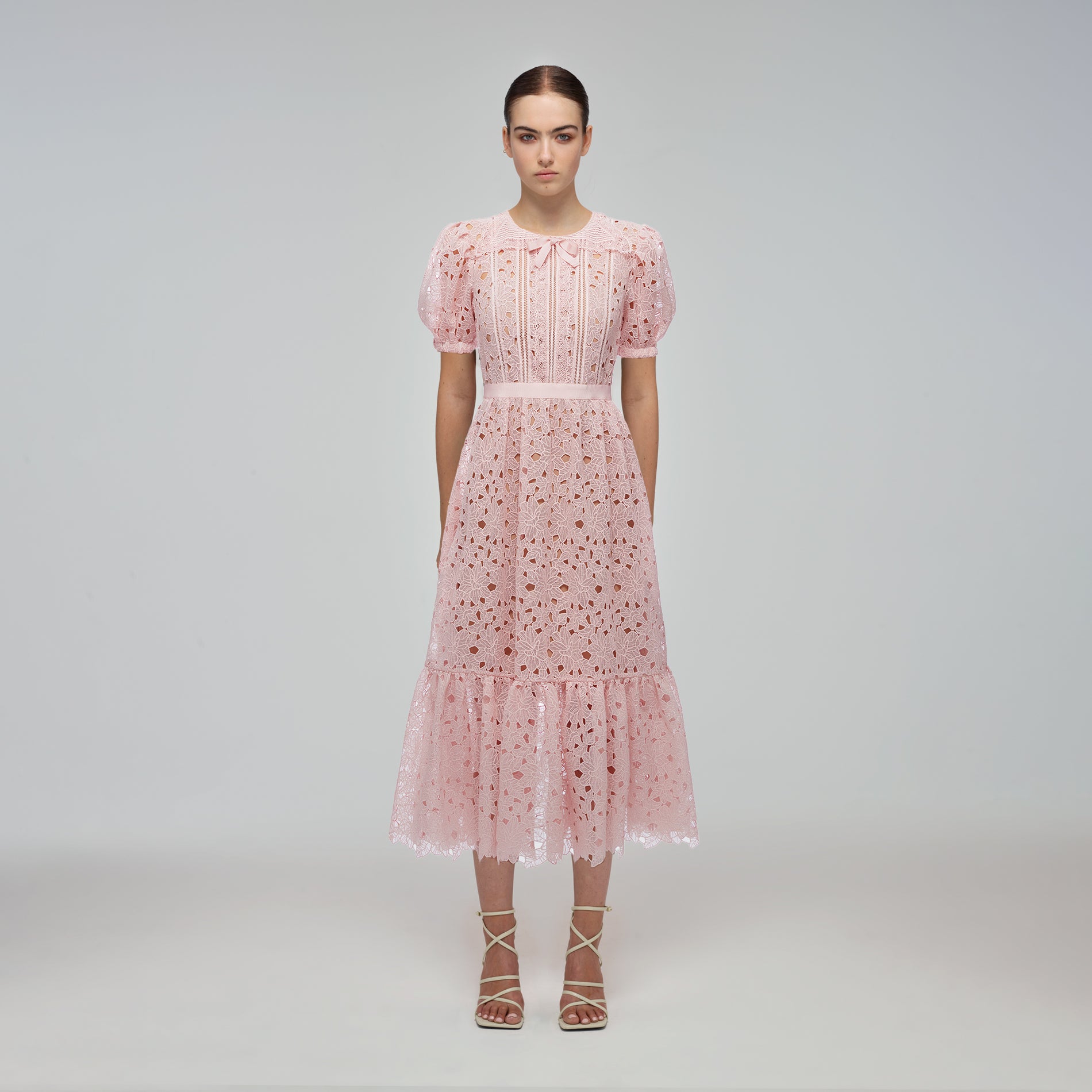 A woman wearing the Blush Guipure Midi Dress