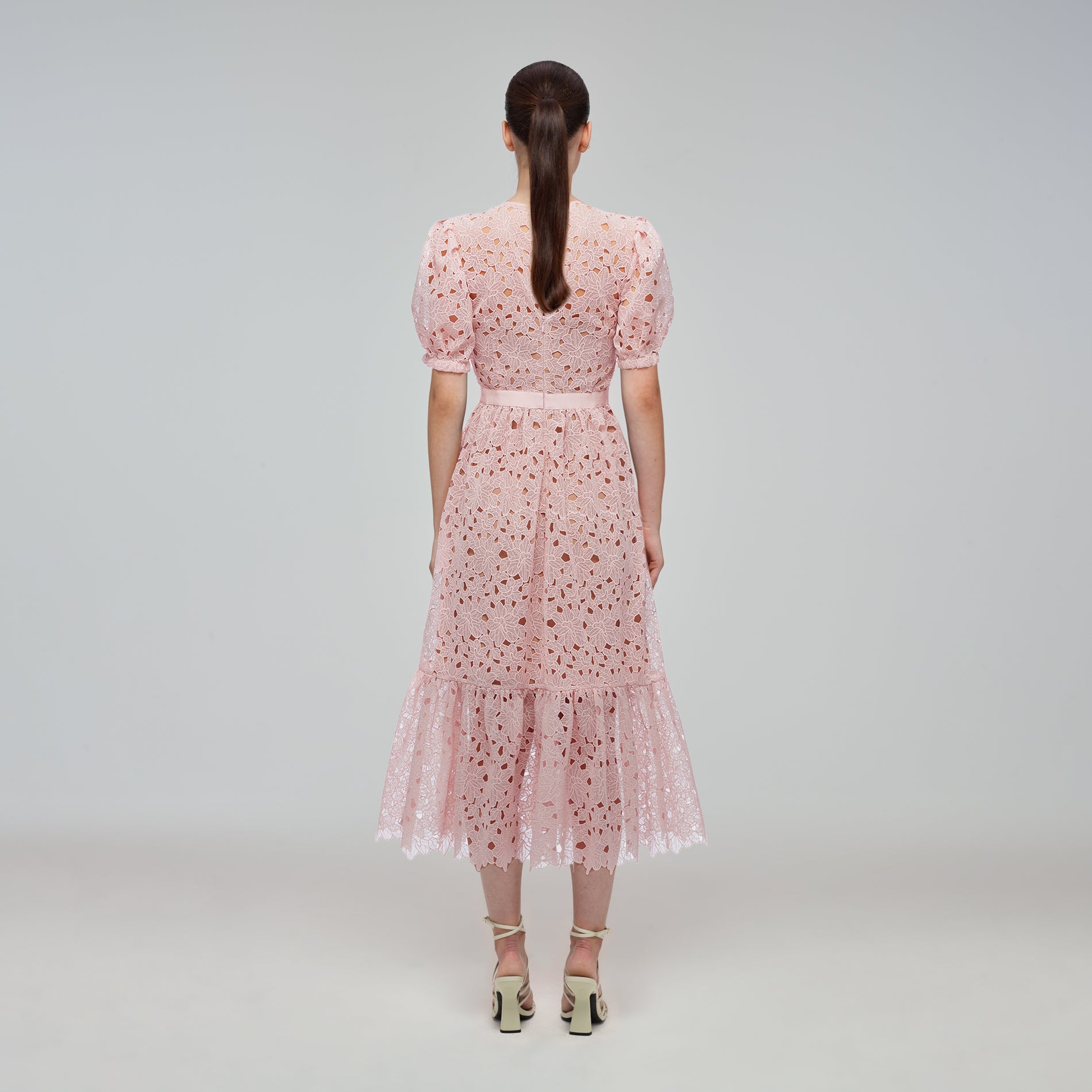 A woman wearing the Blush Guipure Midi Dress