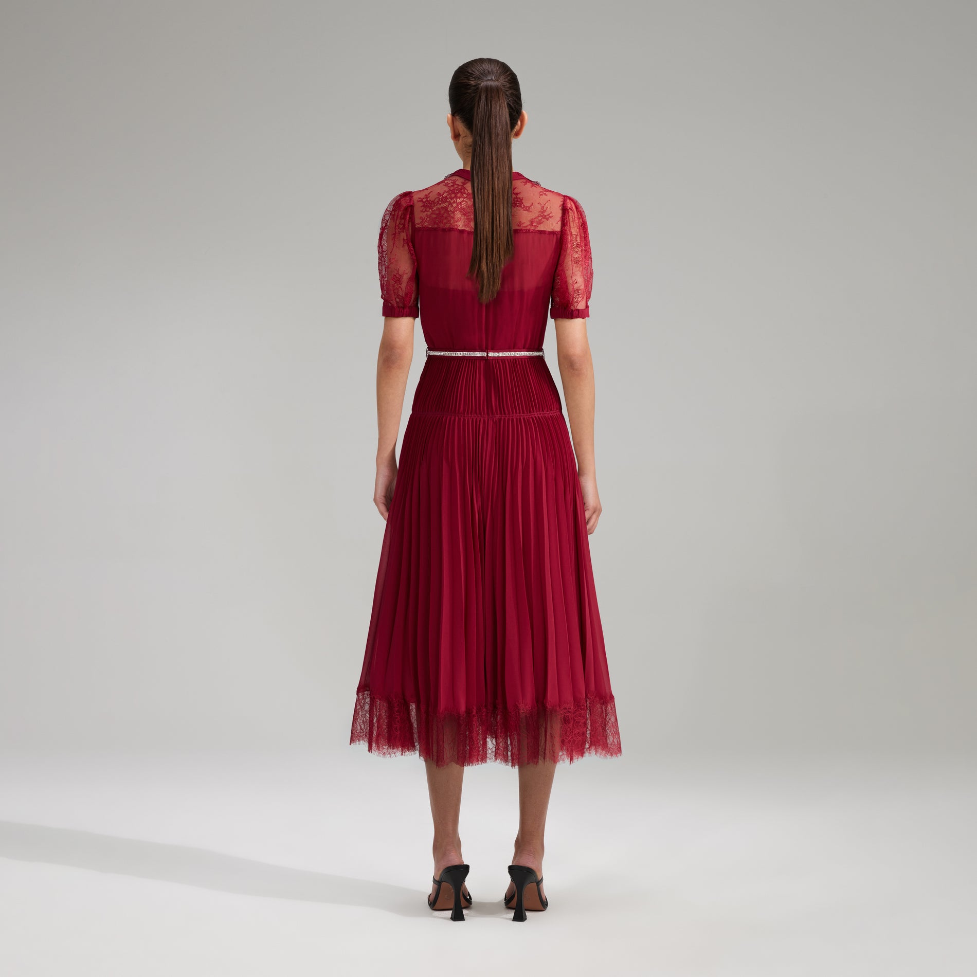 A woman wearing the Burgundy Lace Trim Pleated Midi Dress