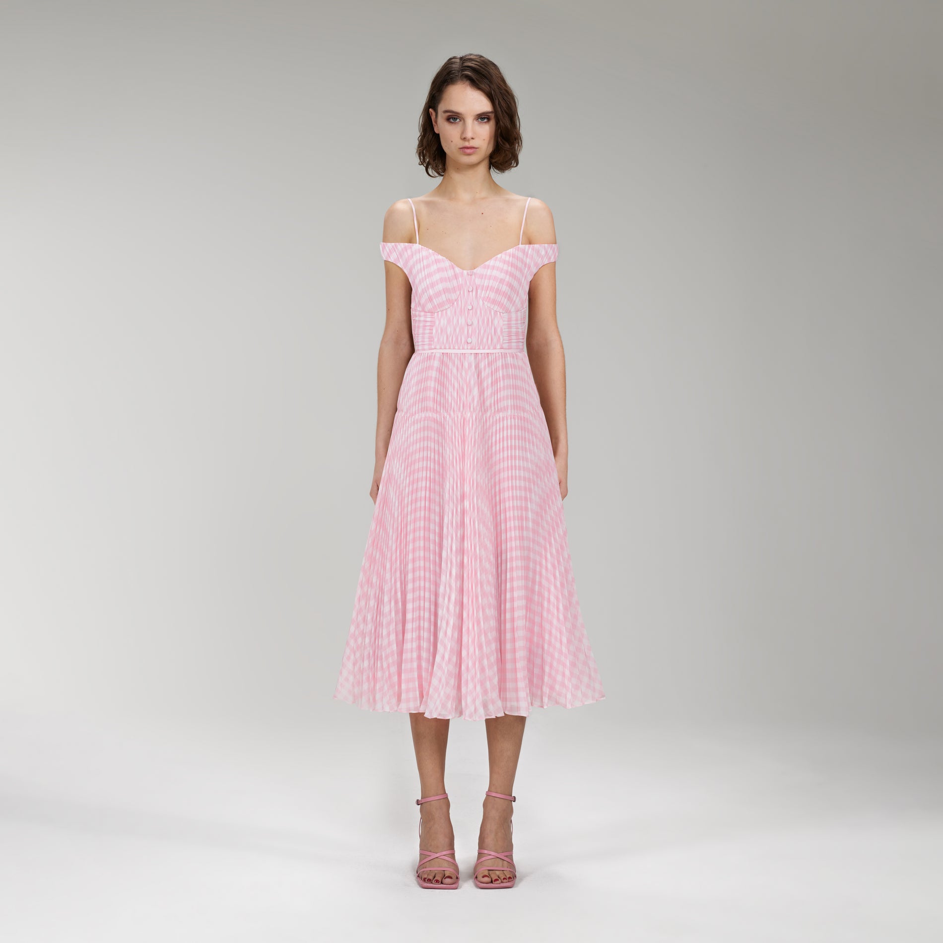 A woman wearing the Pink Gingham Print Chiffon Midi Dress
