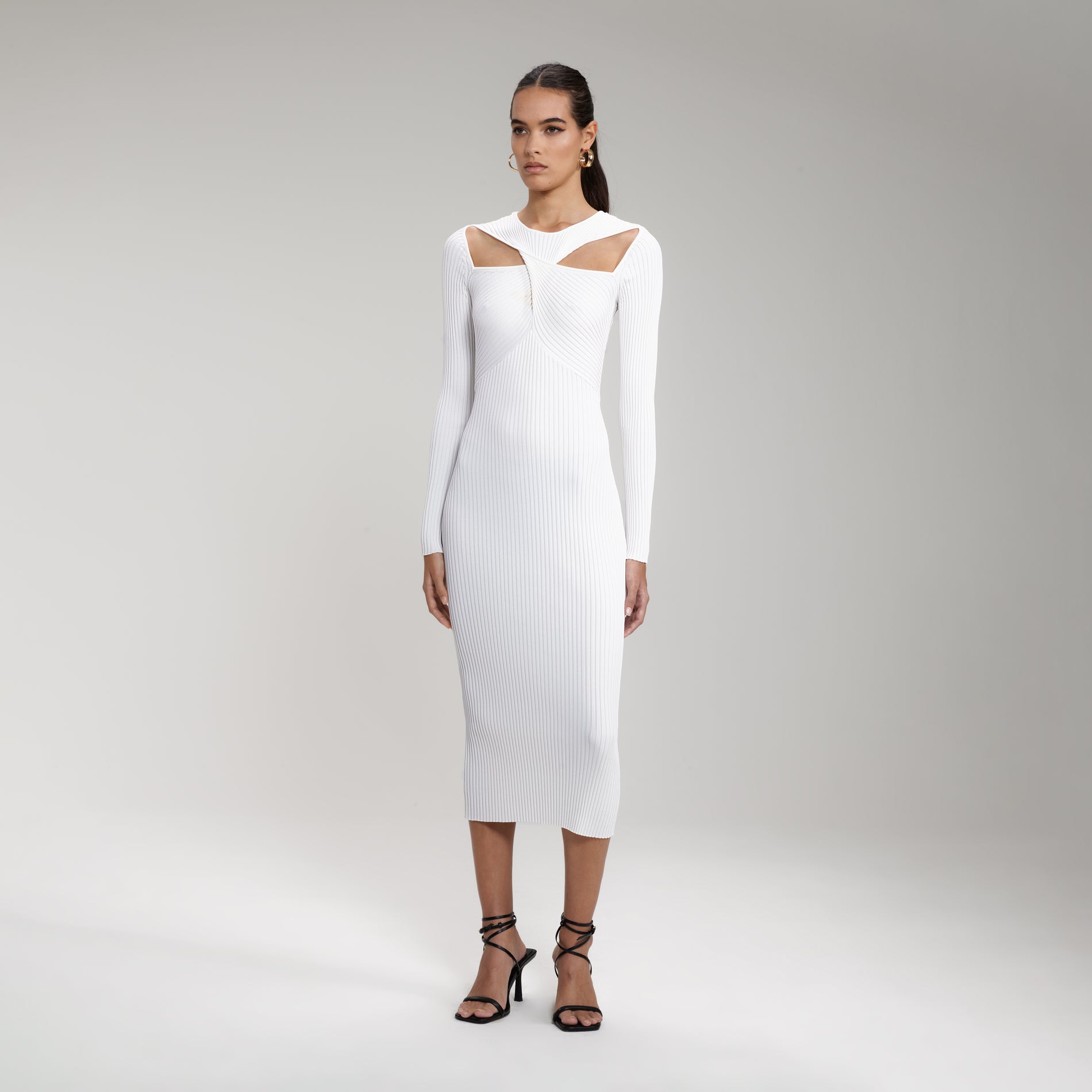 A woman wearing the White Ribbed Knit Cut Out Midi Dress