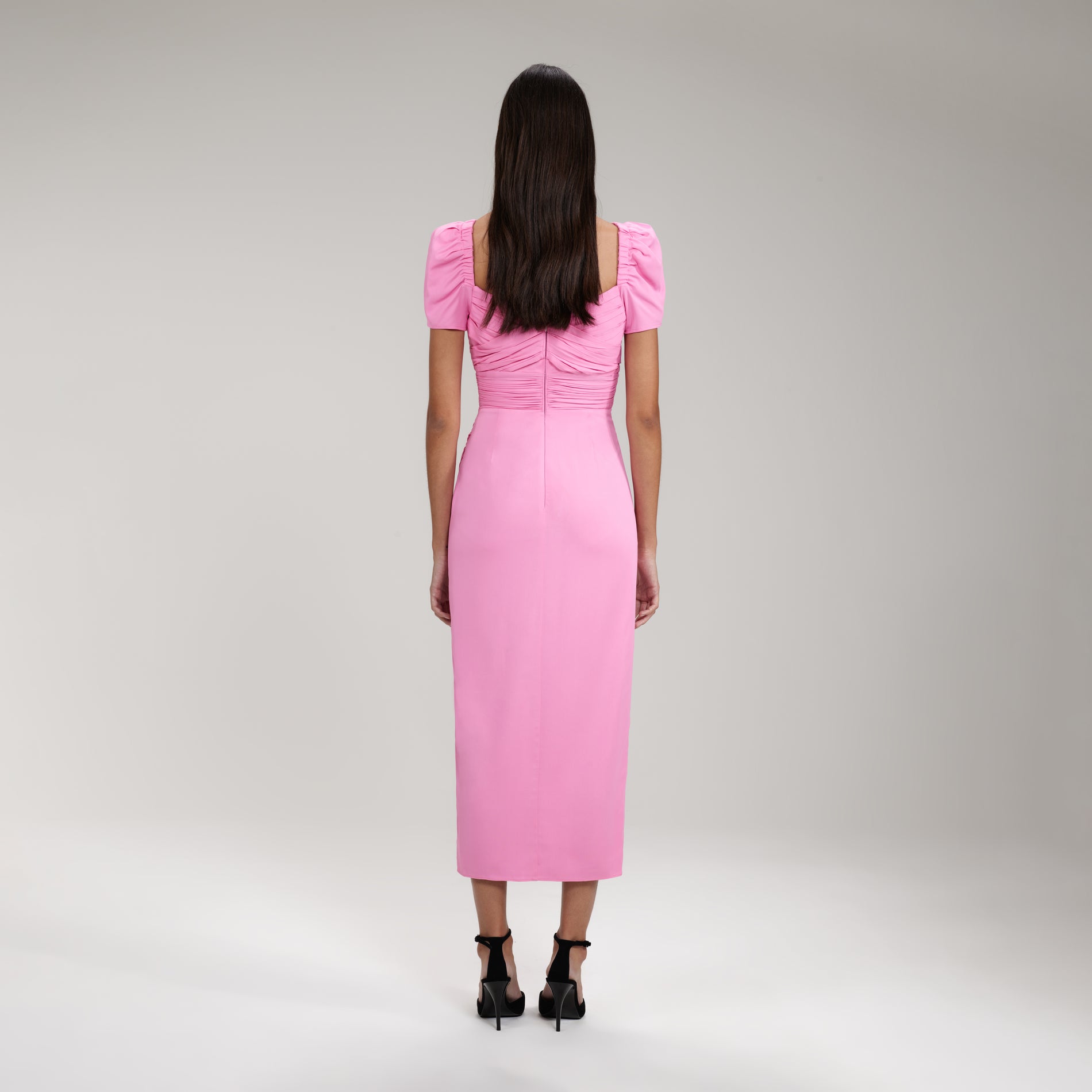 A woman wearing the Pink Iris Midi Dress