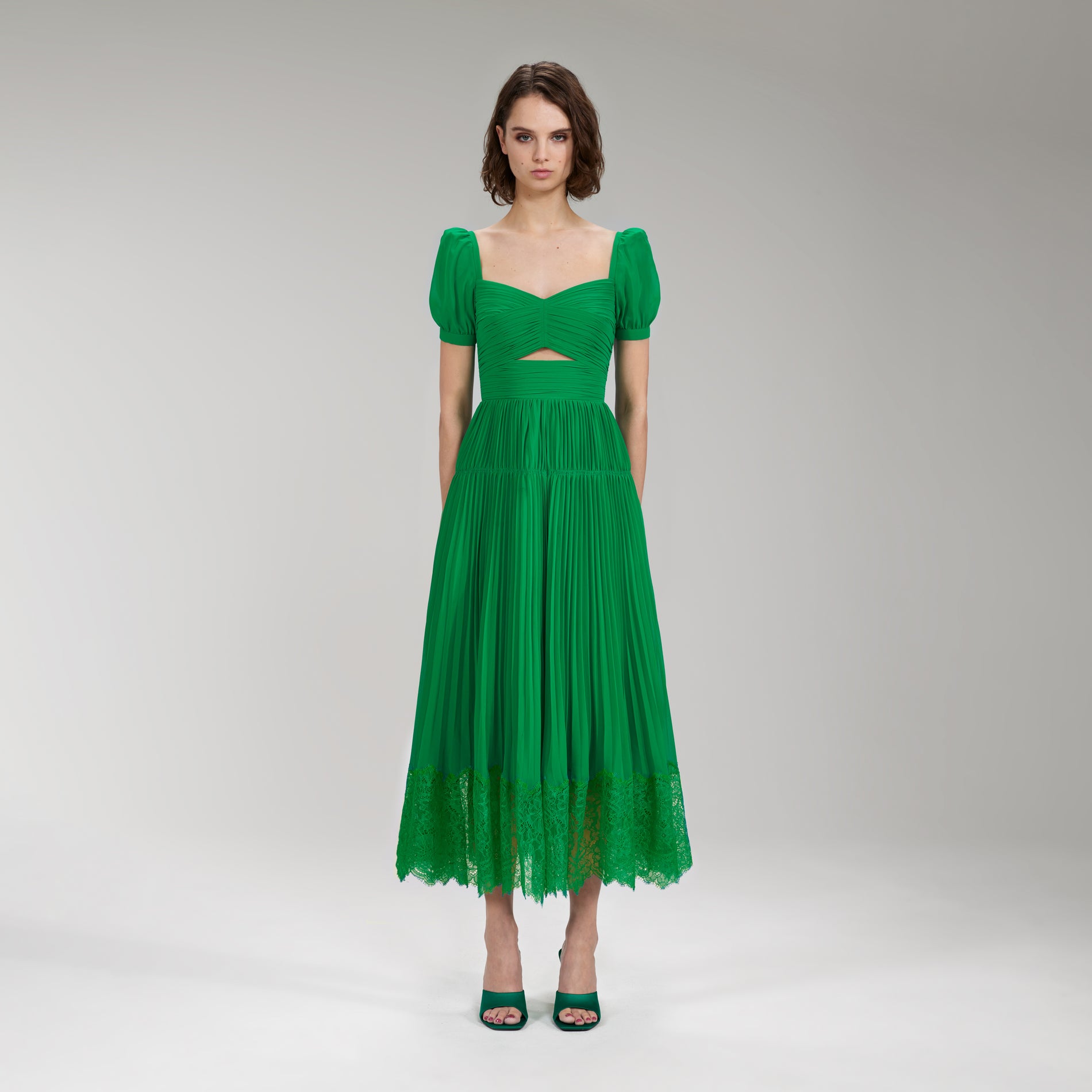 A woman wearing the Bright Green Chiffon Cut Out Midi Dress