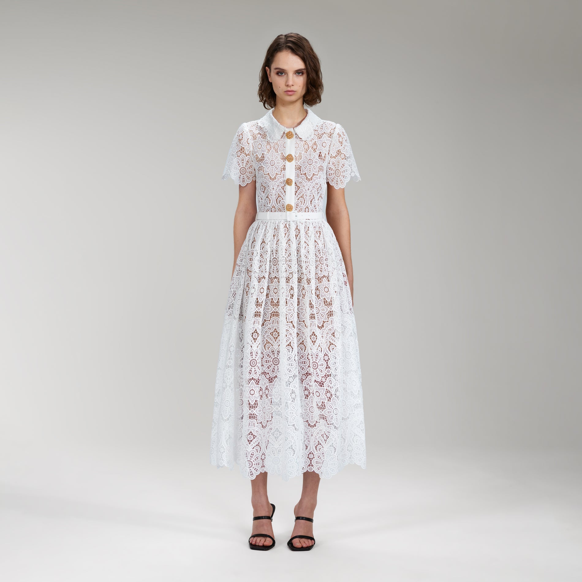 A woman wearing the White Floral Guipure Lace Midi Dress