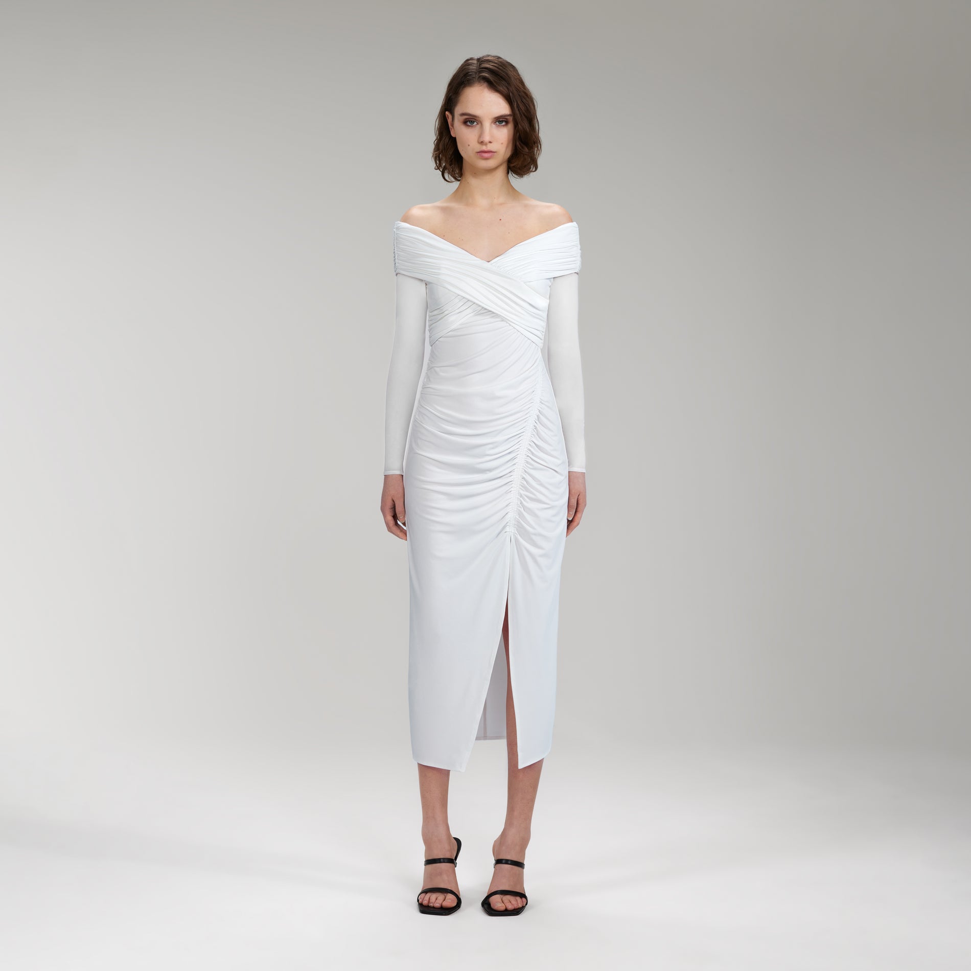 A woman wearing the White Jersey Crossover Bust Midi Dress