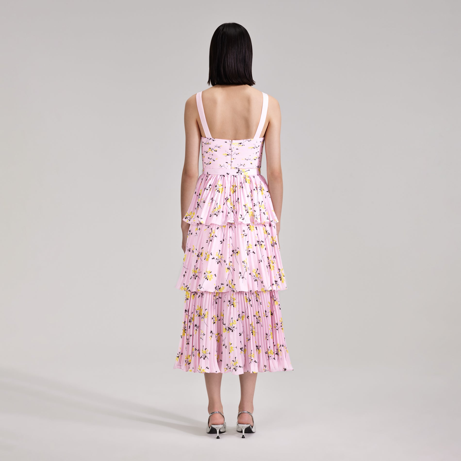 A woman wearing the Pink Floral Print Tiered Midi Dress
