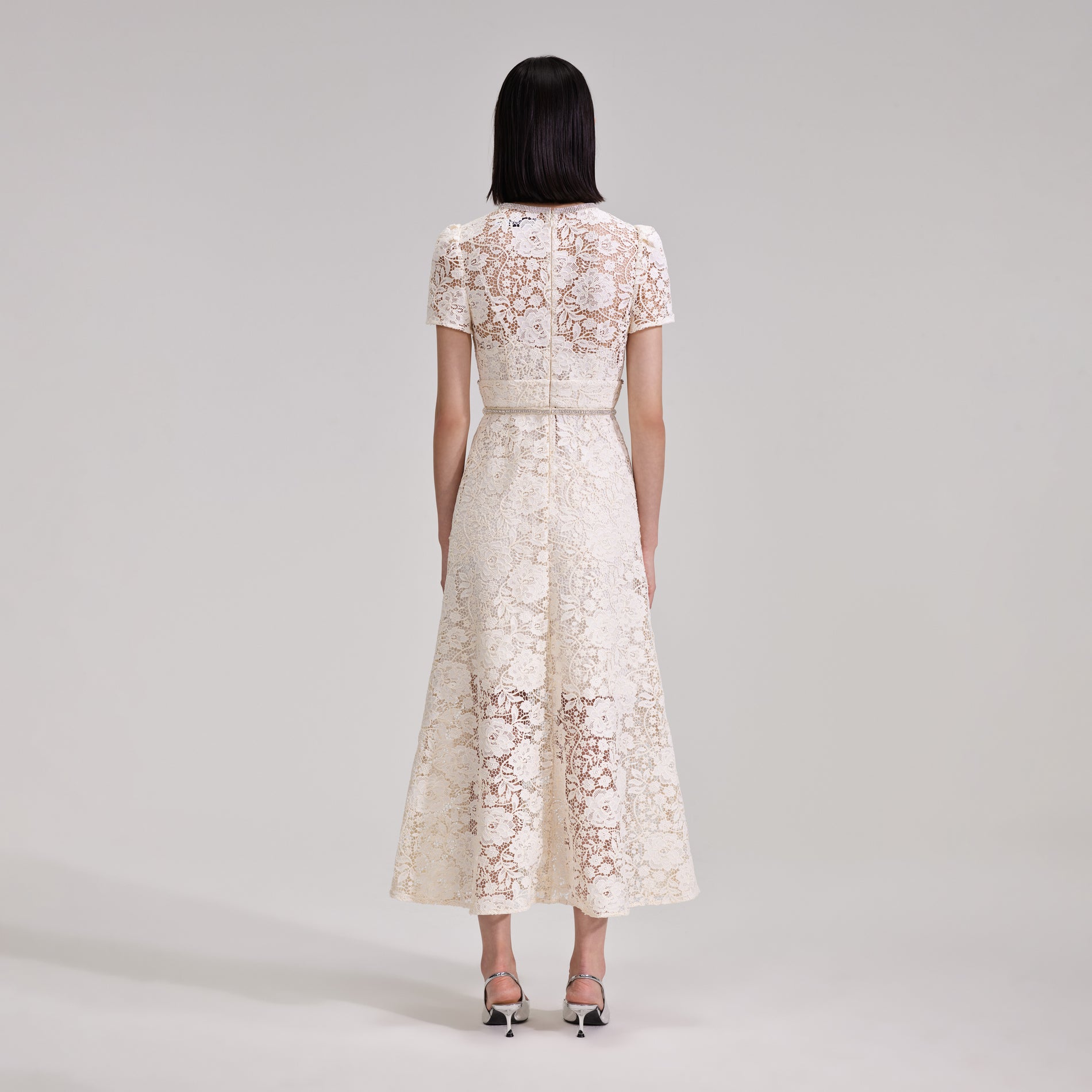 A woman wearing the Cream Cord Lace Bow Midi Dress