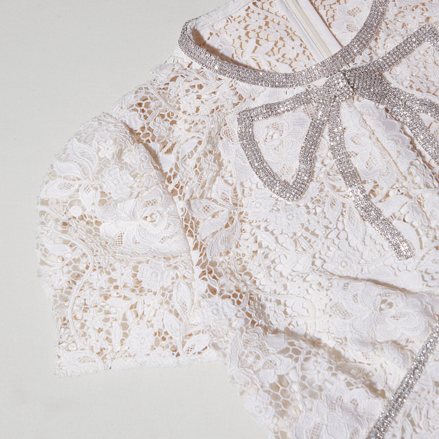 A close up of the fabric for the Cream Cord Lace Bow Midi Dress