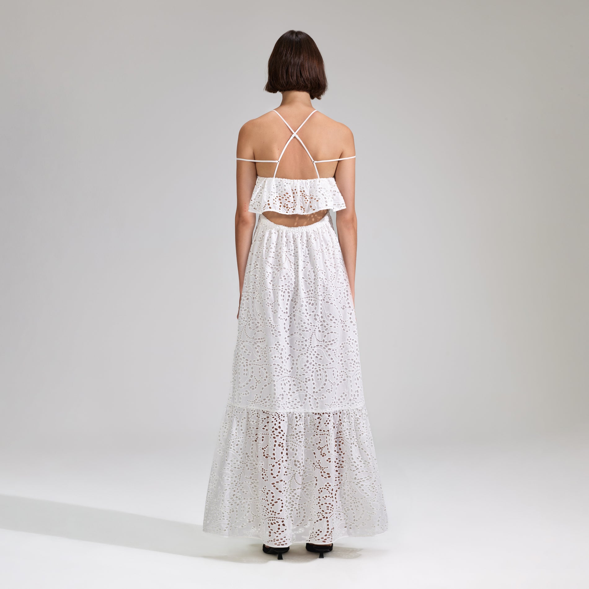 A woman wearing the White Broderie Maxi Dress