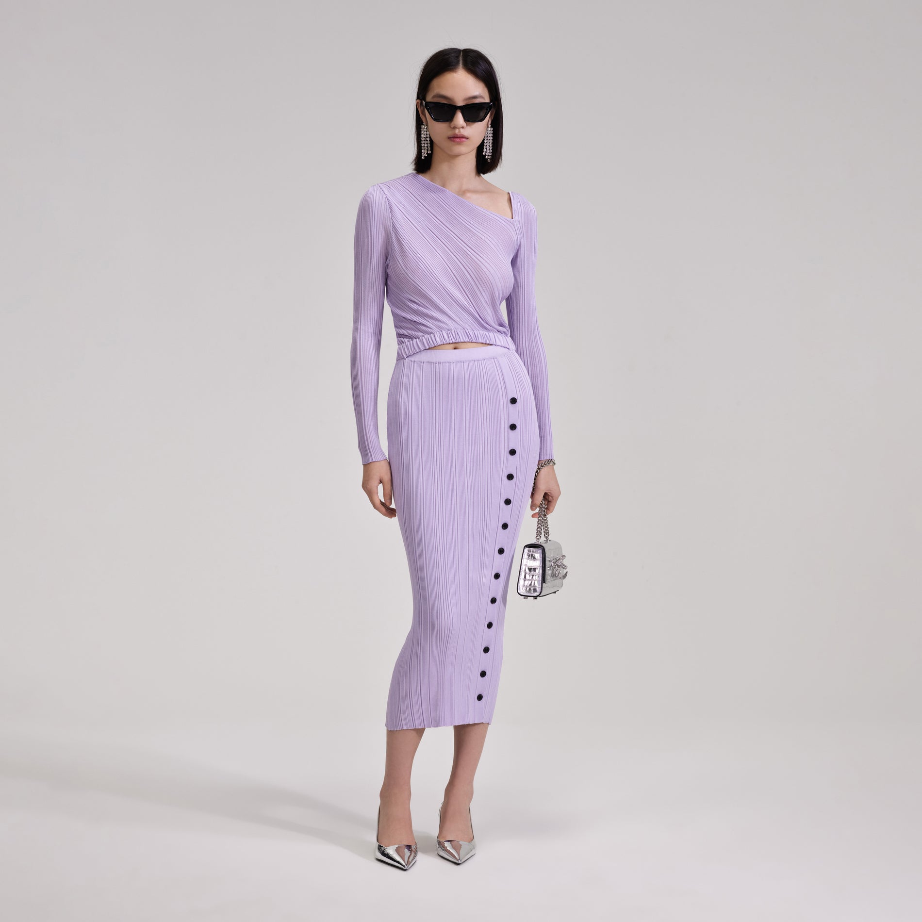 A woman wearing the Lilac Knit Midi Dress