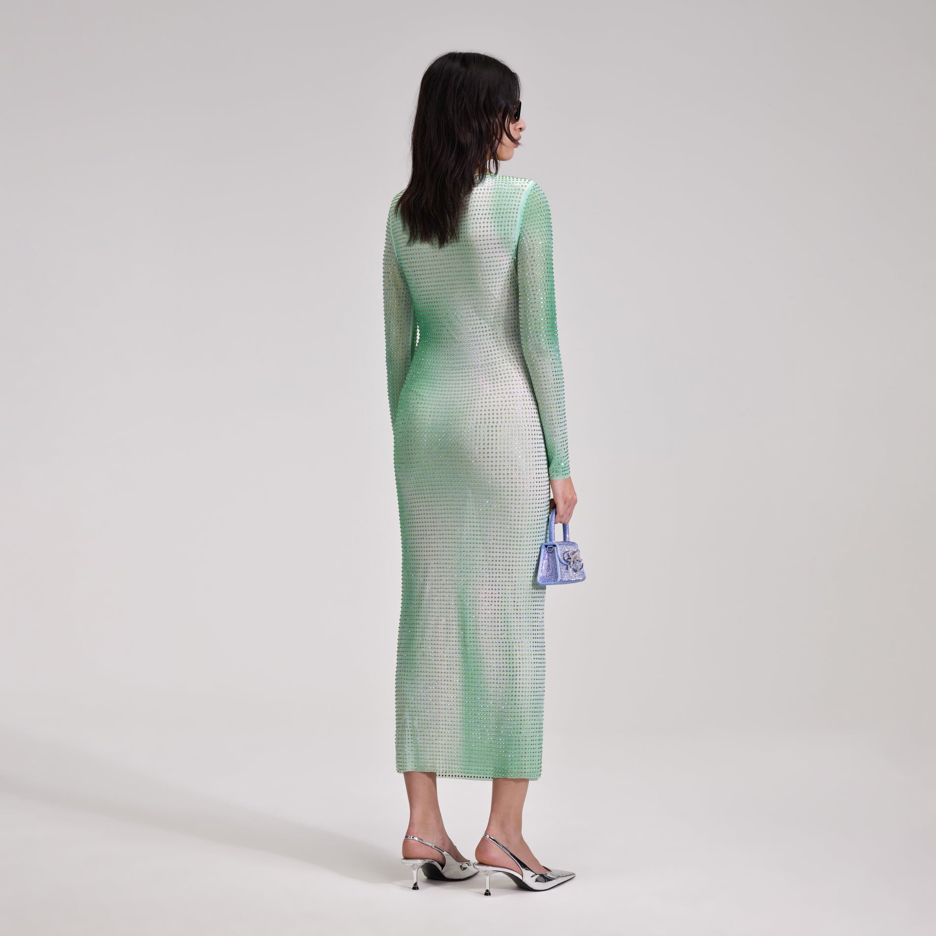 A woman wearing the Green Contour Print Midi Dress