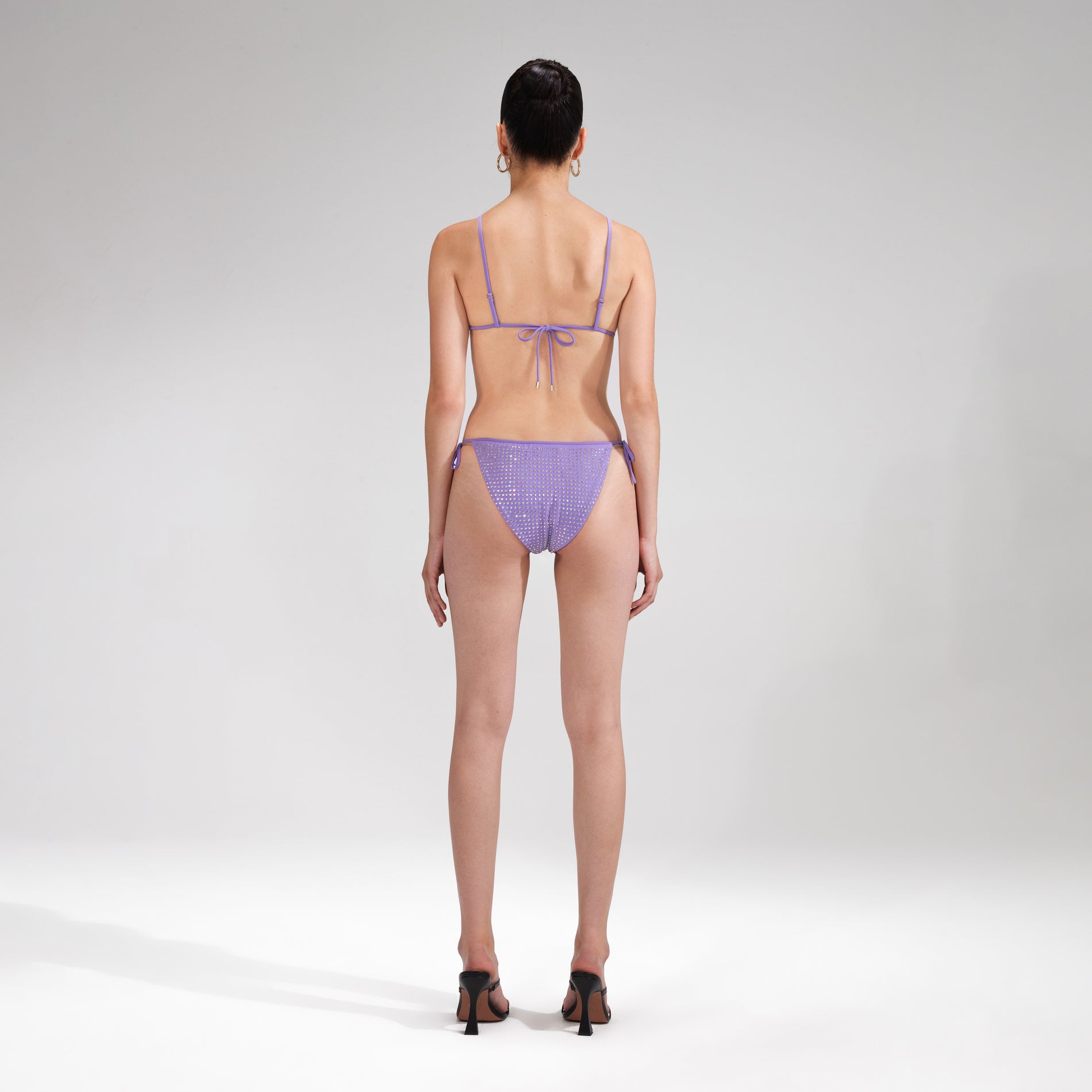 A woman wearing the Purple Rhinestone Bikini Top