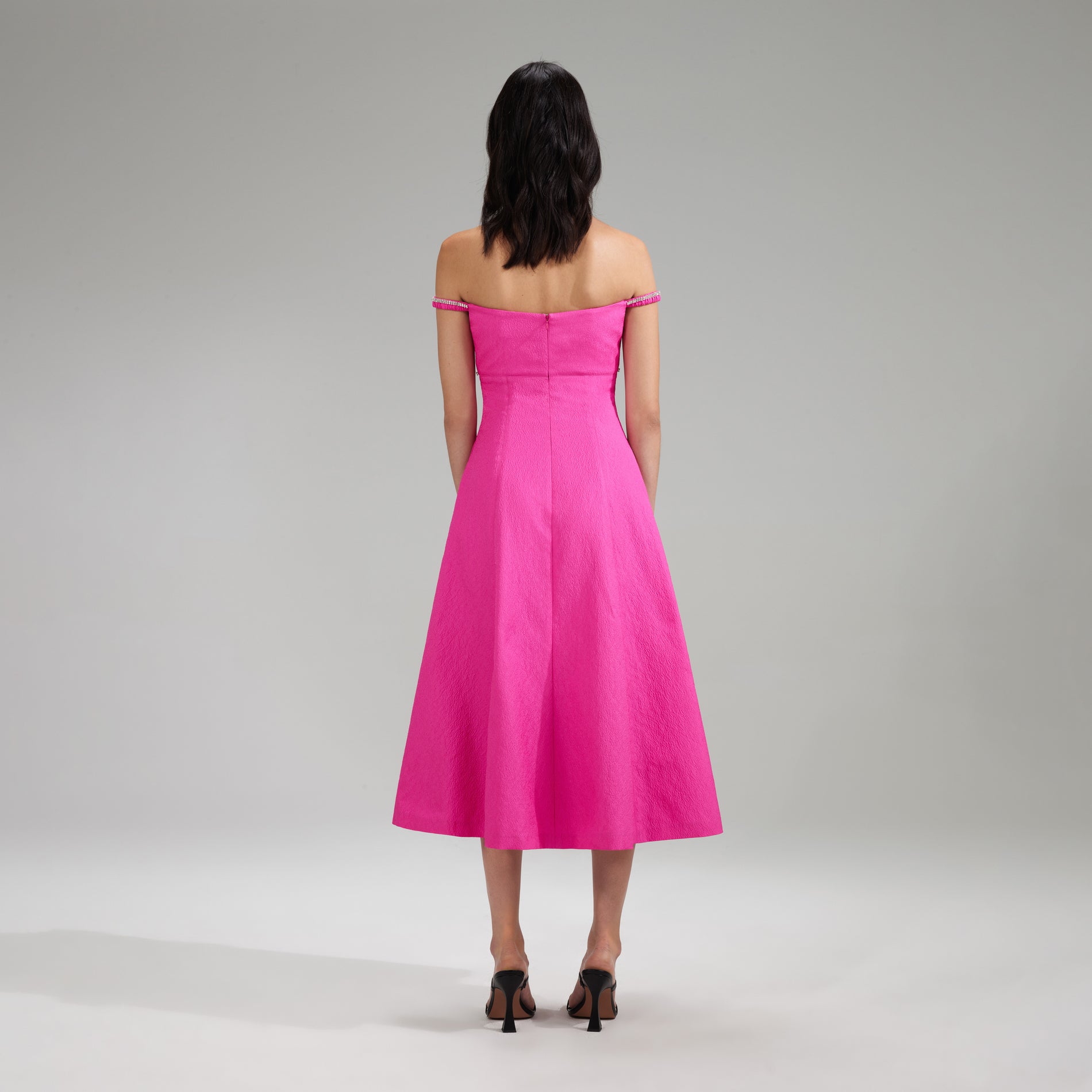 A woman wearing the Pink Textured Diamante Detail Midi Dress