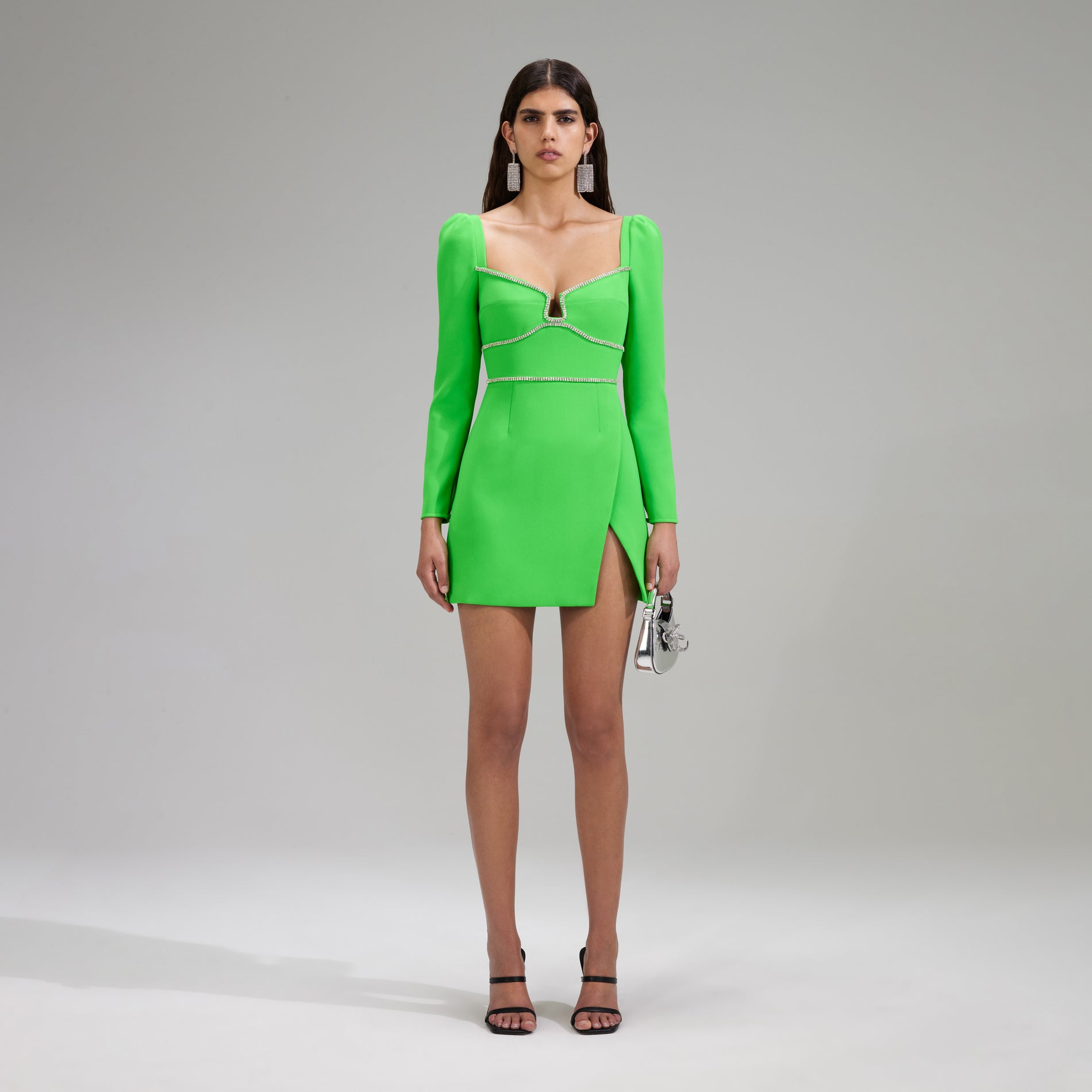 A woman wearing the Green Crepe Rhinestone Detail Mini Dress