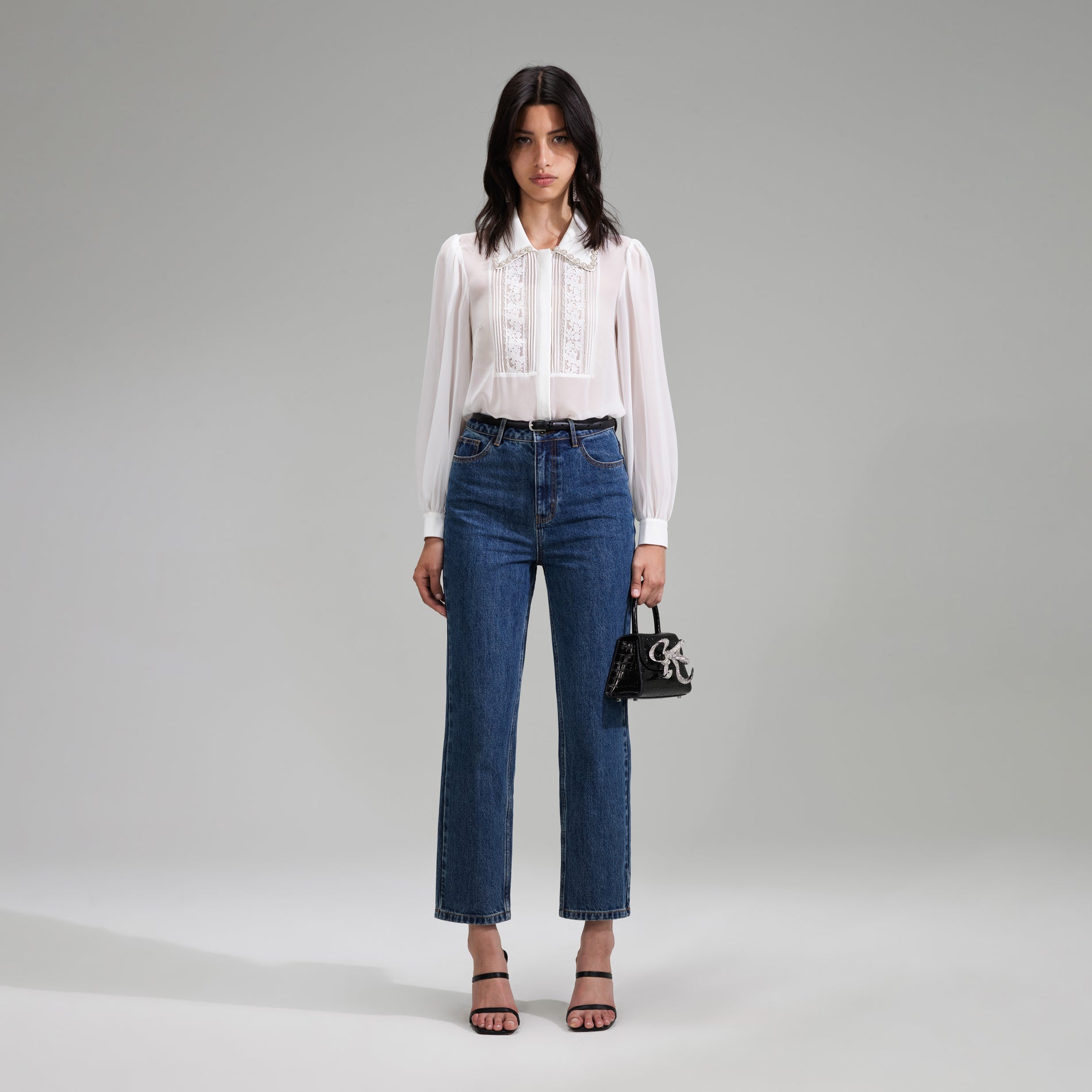 A woman wearing the White Chiffon Rhinestone Detail Top