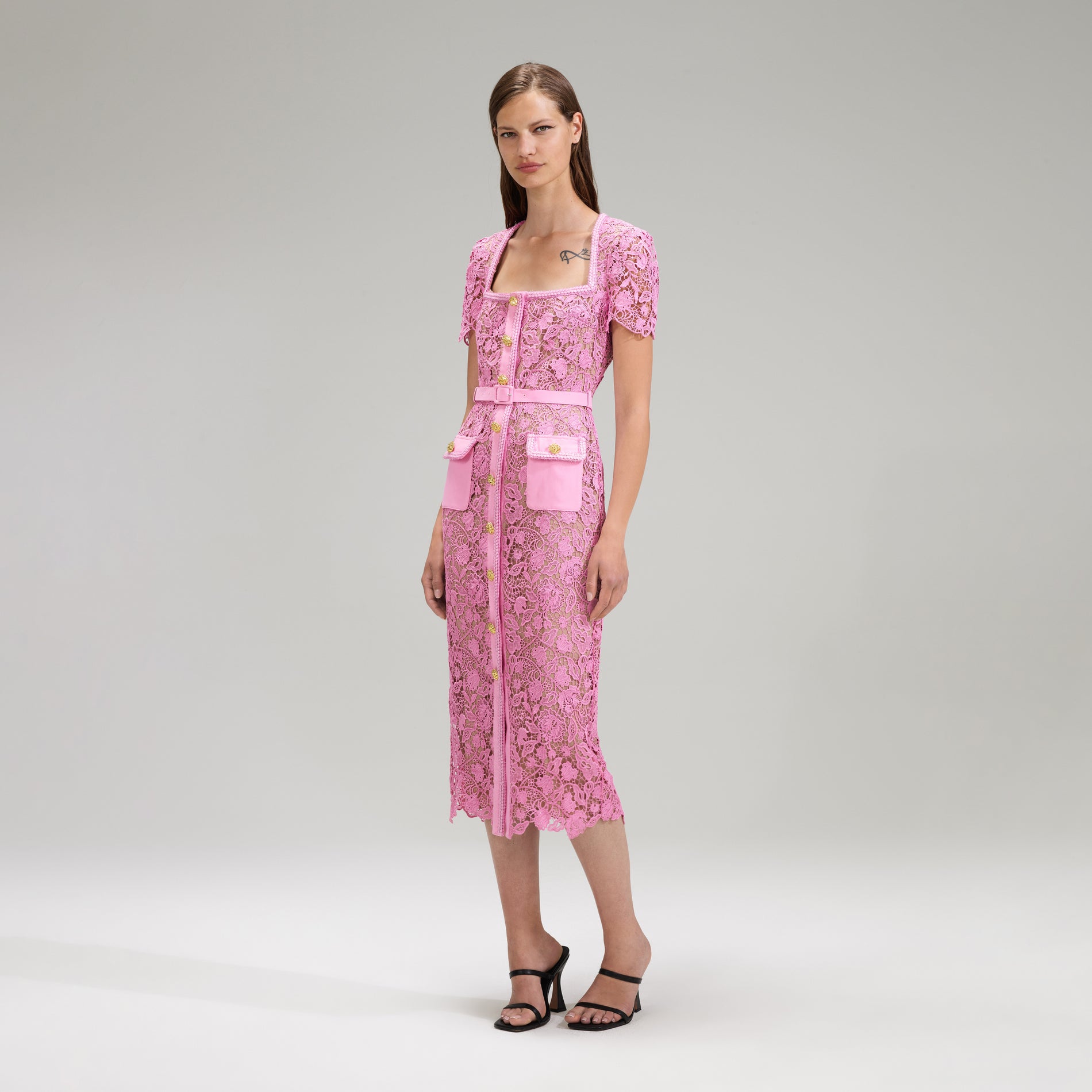 A woman wearing the Pink Guipure Lace Midi Dress