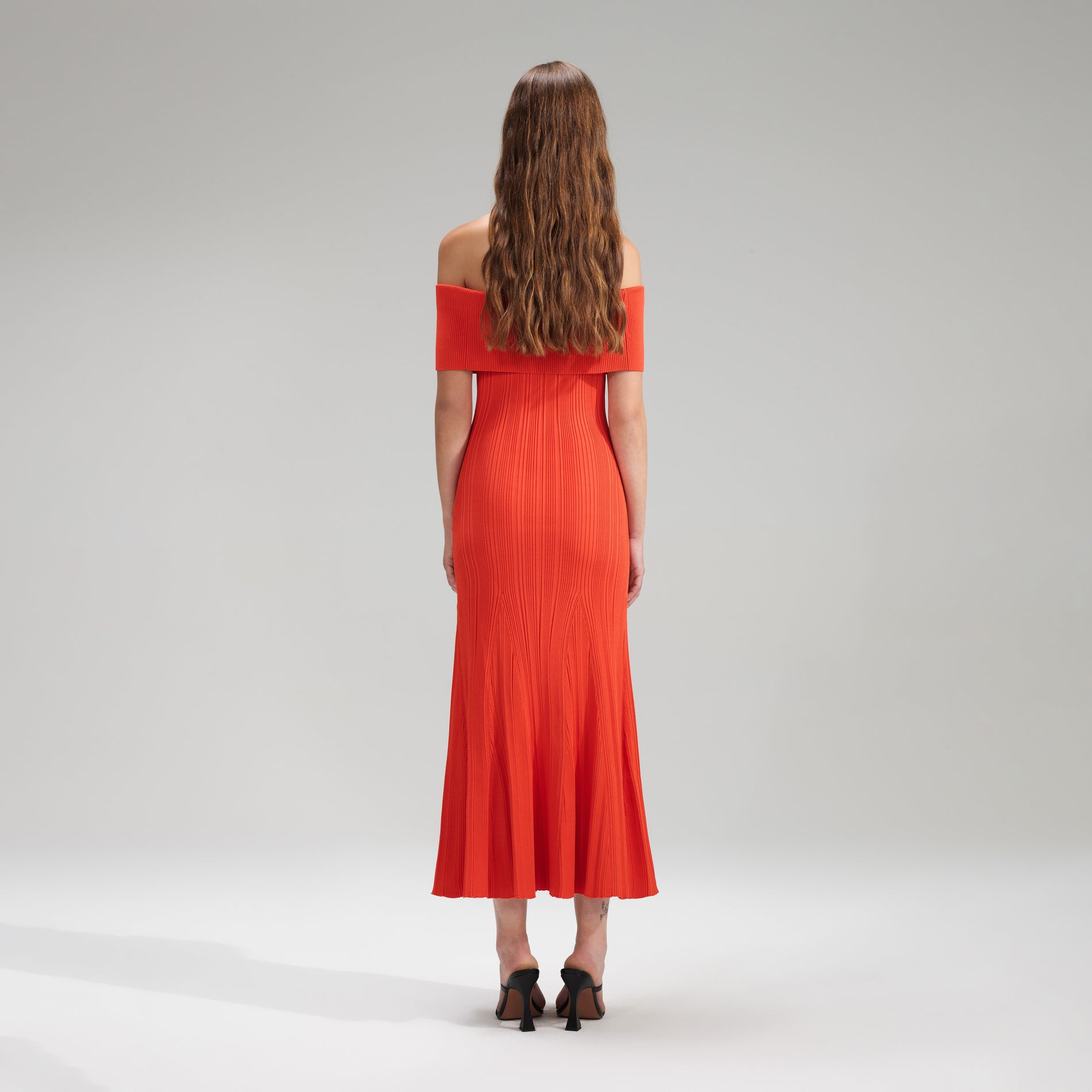 A woman wearing the Red Viscose Knit Midi Dress