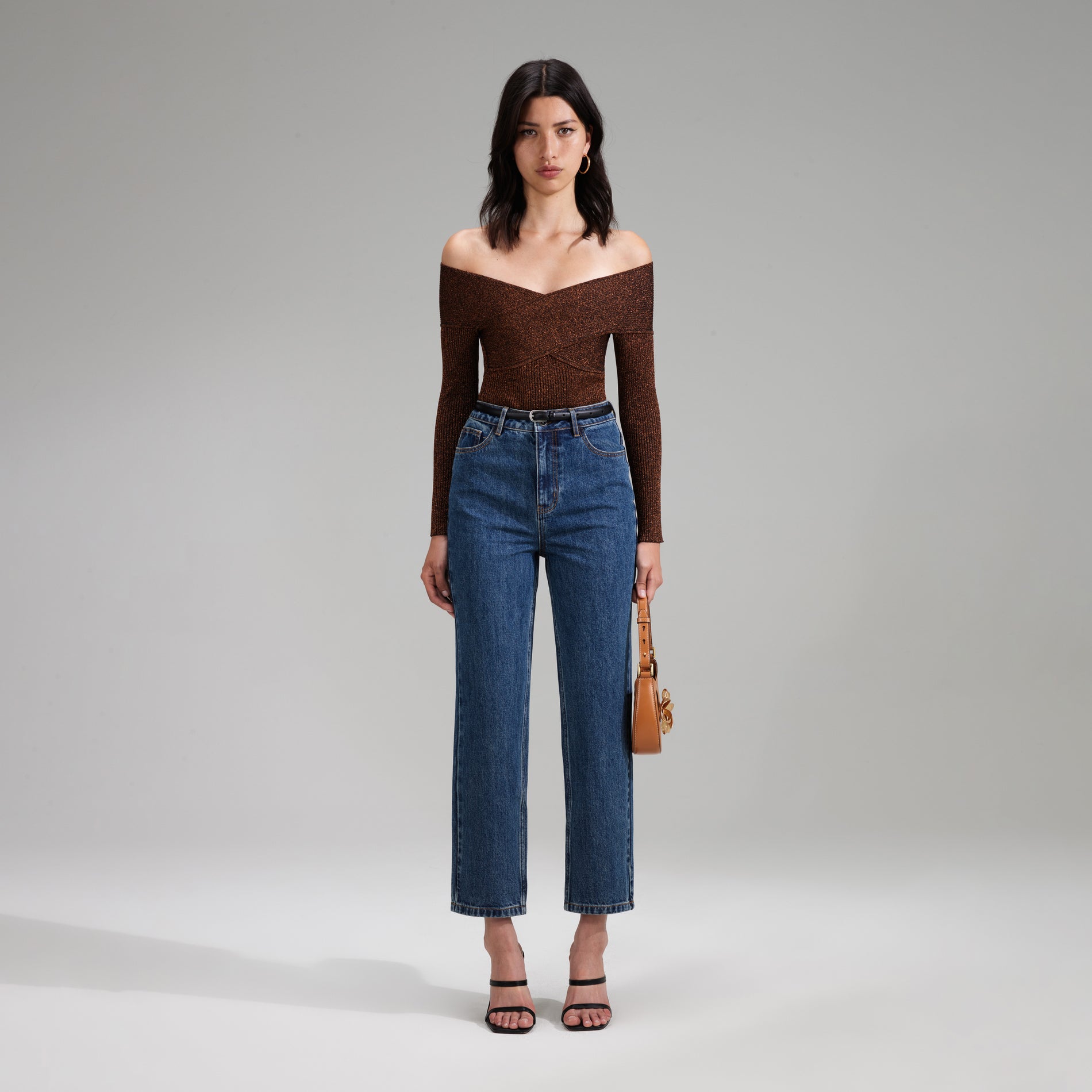 A woman wearing the Brown Lurex Knit Off Shoulder Top