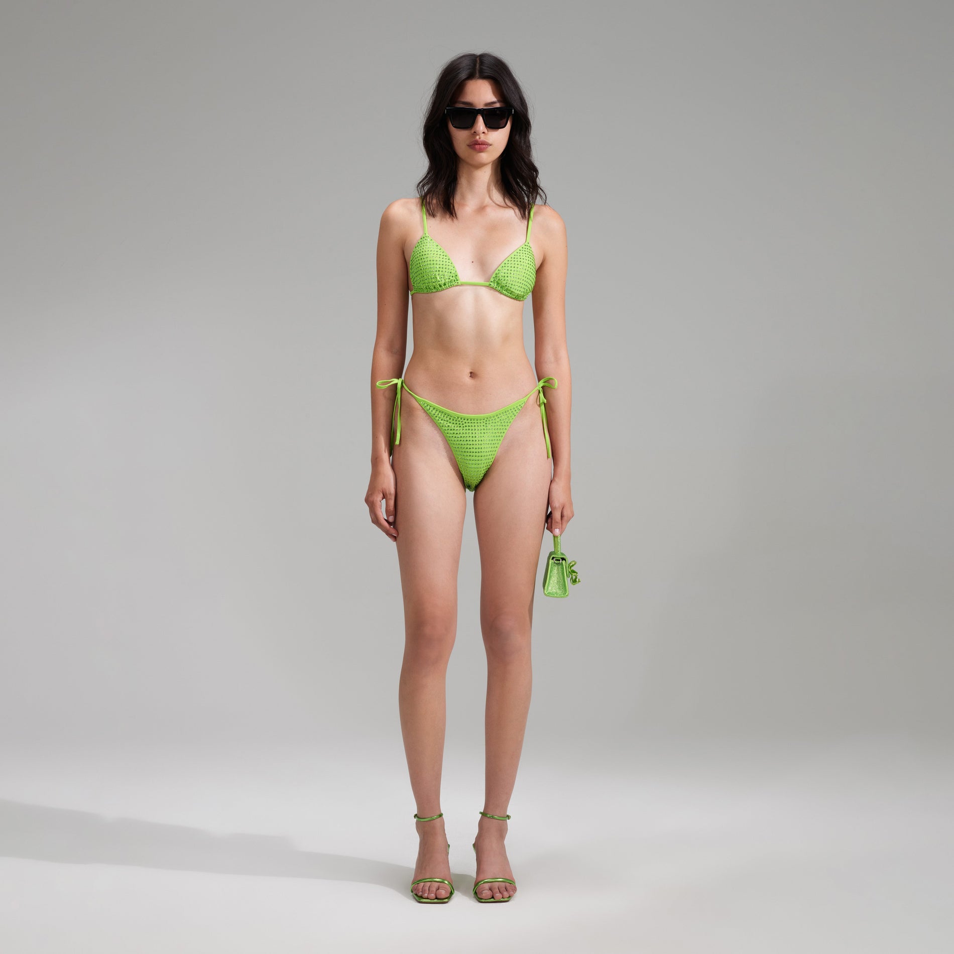 A woman wearing the Green Rhinestone Brazilian Bikini Briefs