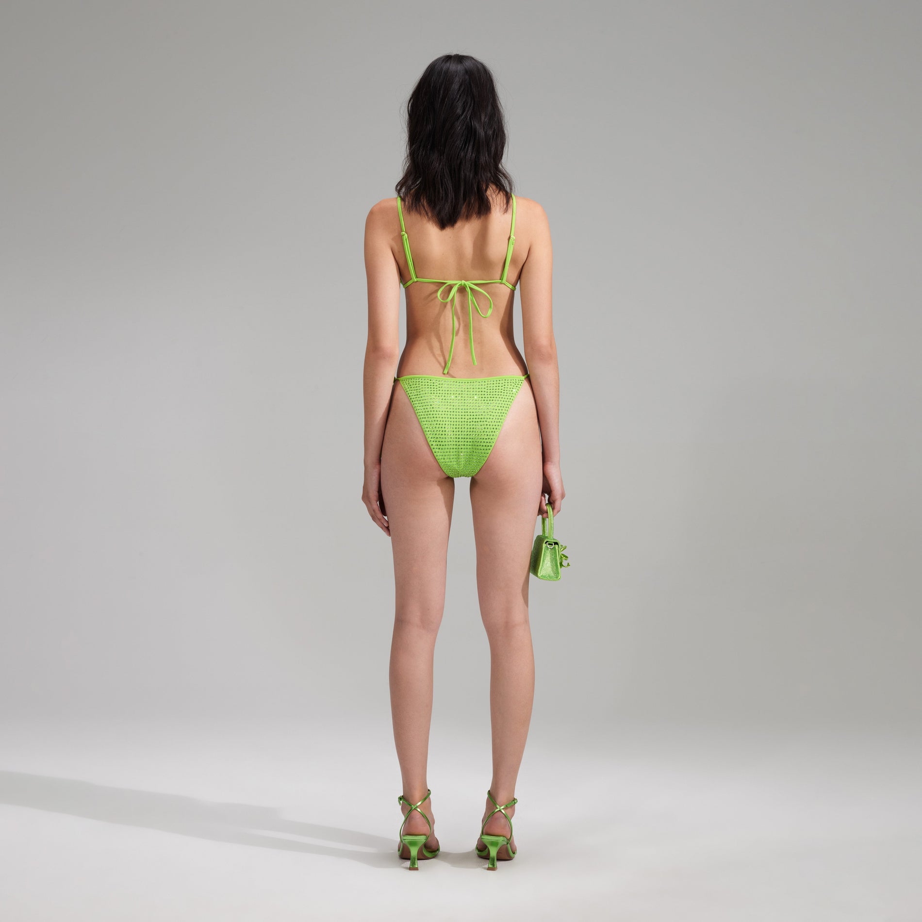 A woman wearing the Green Rhinestone Brazilian Bikini Briefs